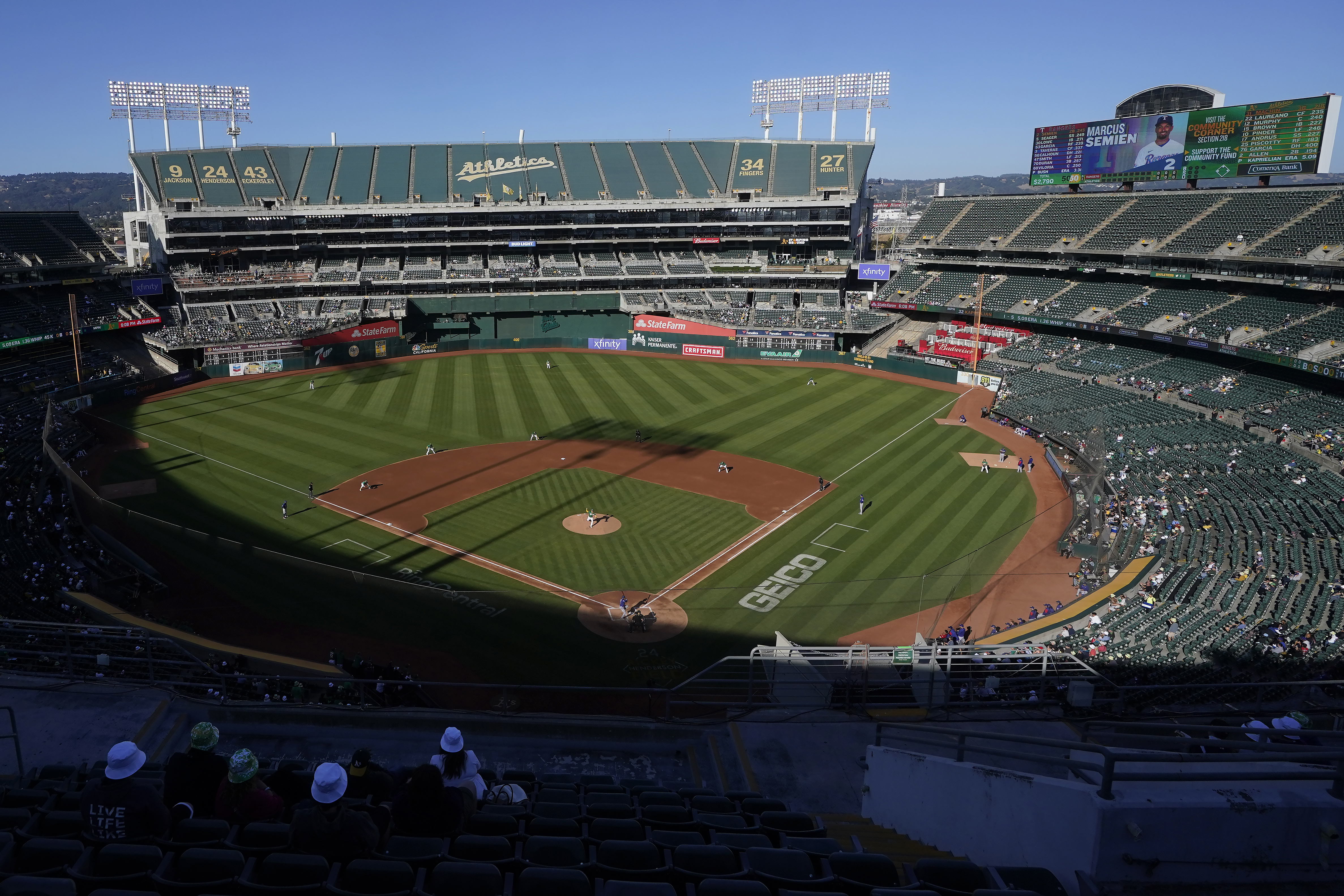 FILE - People watch a baseball game at Oakland Coliseum between the Oakland Athletics and the Texas Rangers in Oakland, Calif., July 23, 2022. The Athletics have signed a binding agreement to purchase land for a new retractable roof stadium in Las Vegas after being unable to build a new venue in the Bay Area. Team president Dave Kaval said Wednesday, April 19, 2023, that the team finalized the deal to buy the 49-acre site last week close to the Las Vegas Strip. 