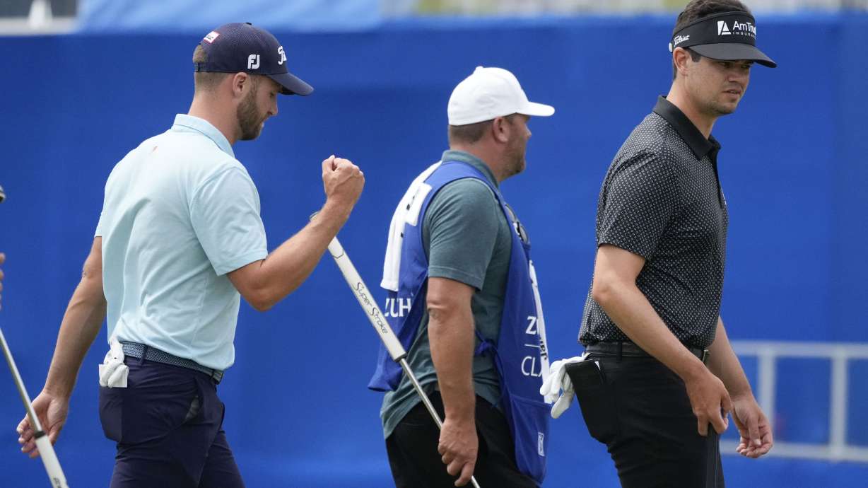 Wyndham Clark, left, and his teammate Beau Hossler, right, walk off the 9th green after finishing for the day during the second round of the PGA Zurich Classic golf tournament at TPC Louisiana in Avondale, La., Friday, April 21, 2023.