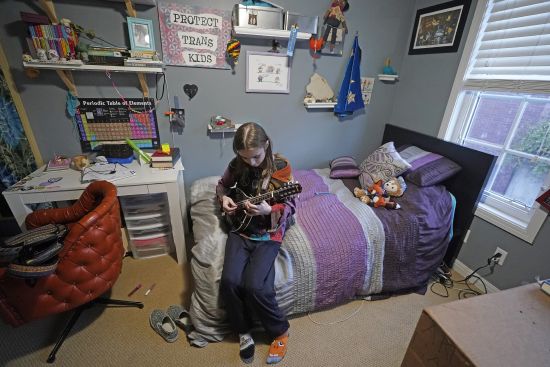 Elle Palmer, 13, plays her mandolin Feb. 7 in Salt Lake City. Elle remembers her first day at the school after she transferred. Before leaving, she came downstairs in rainbow sparkle-embroidered cowboy boots her mother worried would only spur bullies. Taunts from kids at Elle’s prior school drove her into depression so deep she had suicidal thoughts.