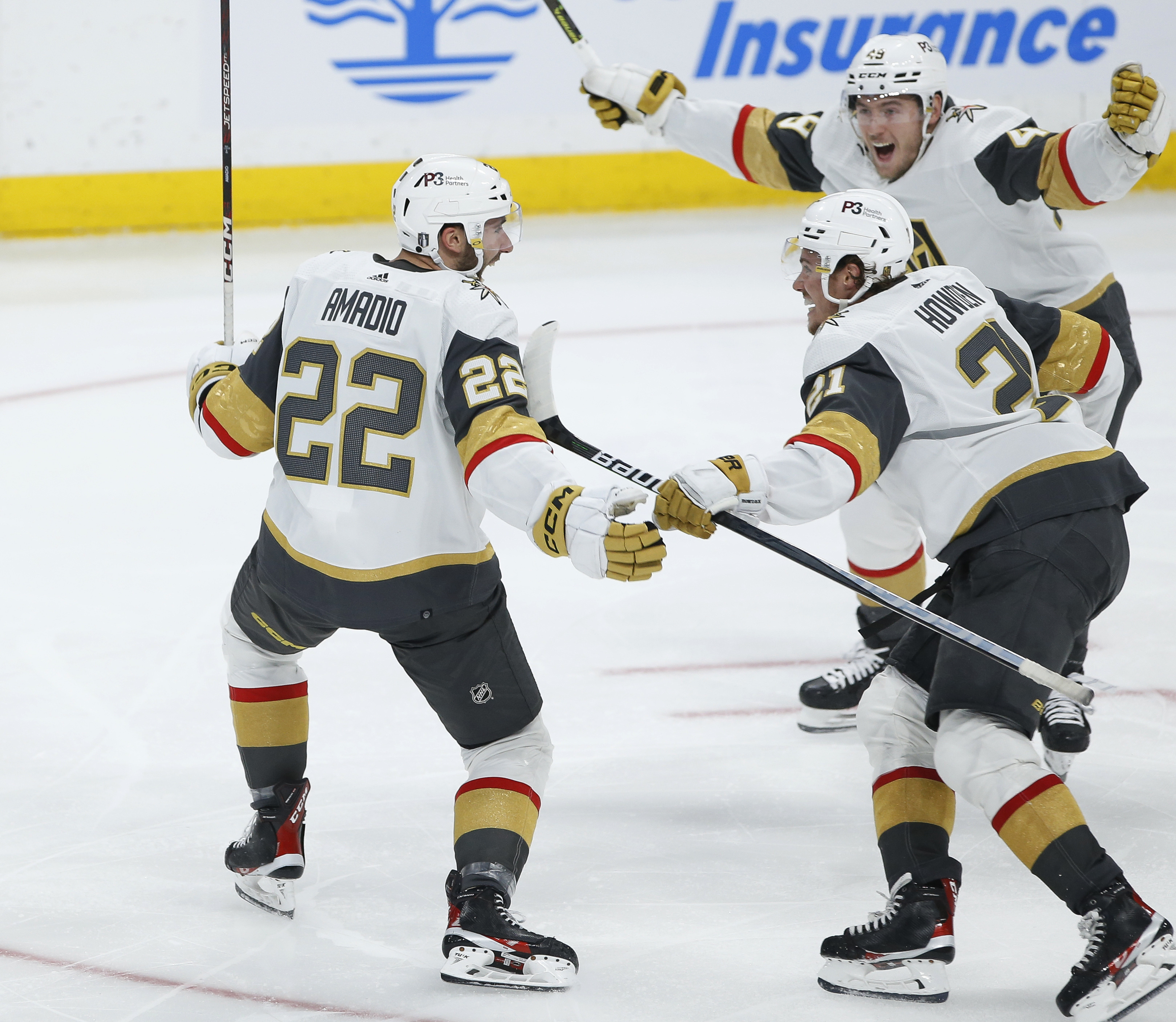 Vegas Golden Knights' Michael Amadio (22), Brett Howden (21) and Ivan Barbashev (49) celebrate Amadio's goal against the Winnipeg Jets in the second overtime in Game 3 of an NHL hockey Stanley Cup first-round playoff series in Winnipeg, Manitoba, Saturday, April 22, 2023. 