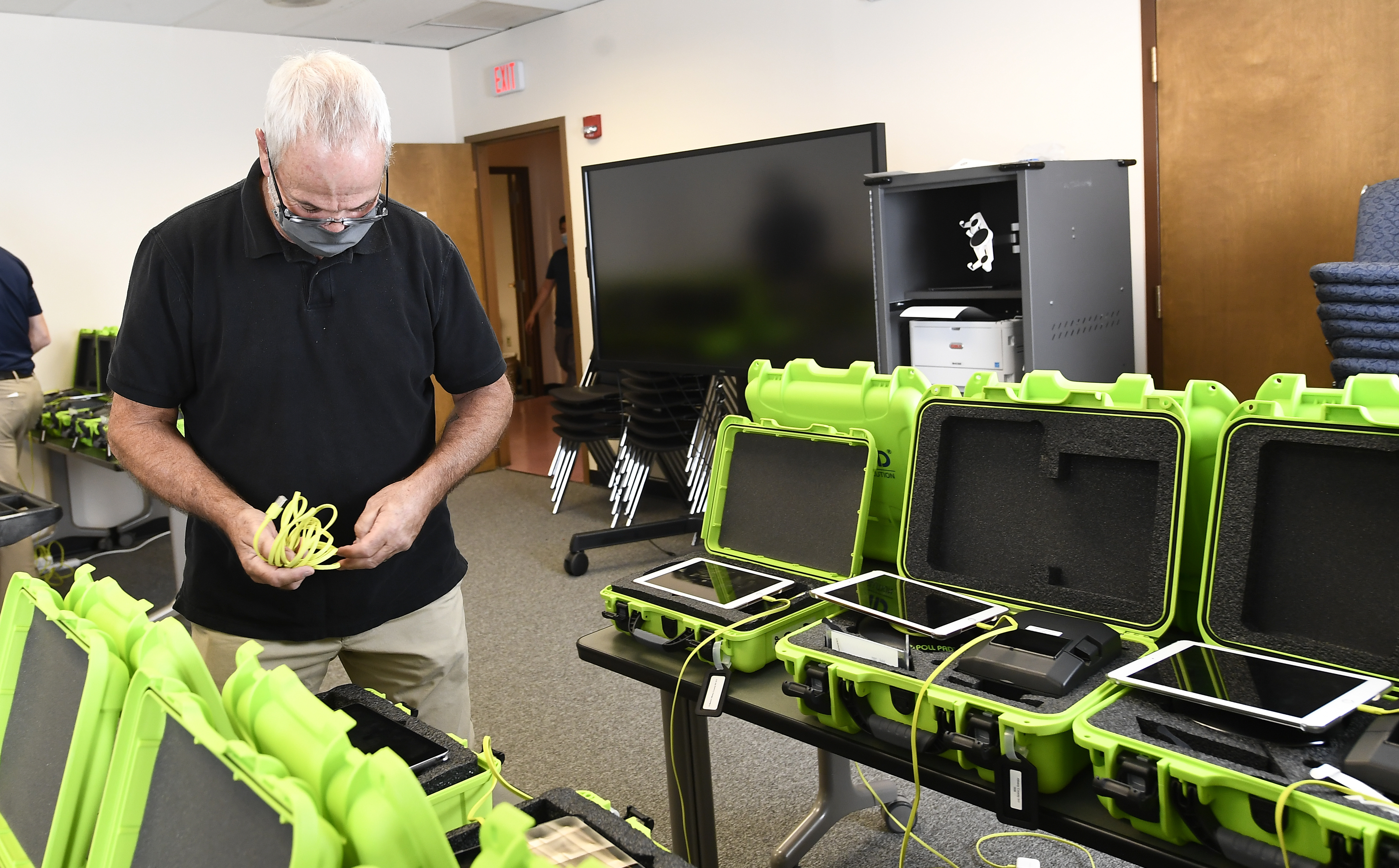 Mark Splonskowski assembles electronic poll book kits in Albany, N.Y. An effort to create a national testing program for technology central to U.S elections will get underway later this year.