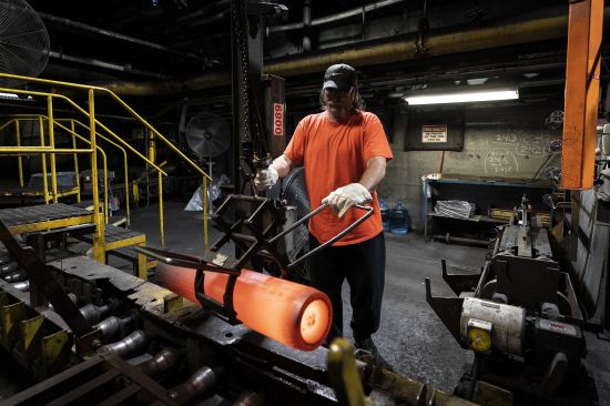 A steel worker removes a heated 155 mm M795 artillery projectile for testing during the manufacturing process at the Scranton Army Ammunition Plant in Scranton, Pa., April 13. One of the most important munitions of the Ukraine war comes from a historic factory in this city built by coal barons, where tons of steel rods are brought in by train to be forged into the artillery shells Kyiv can’t get enough of — and that the U.S. can’t produce fast enough.