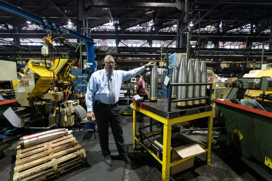 Richard Hansen, a Navy veteran who is the Army commander's representative at the Scranton Army Ammunition Plant with members of the media during a tour of the manufacturing process of 155 mm M795 artillery projectiles in Scranton, Pa., April 13. One of the most important munitions of the Ukraine war comes from a historic factory in this city built by coal barons, where tons of steel rods are brought in by train to be forged into the artillery shells Kyiv can’t get enough of — and that the U.S. can’t produce fast enough.