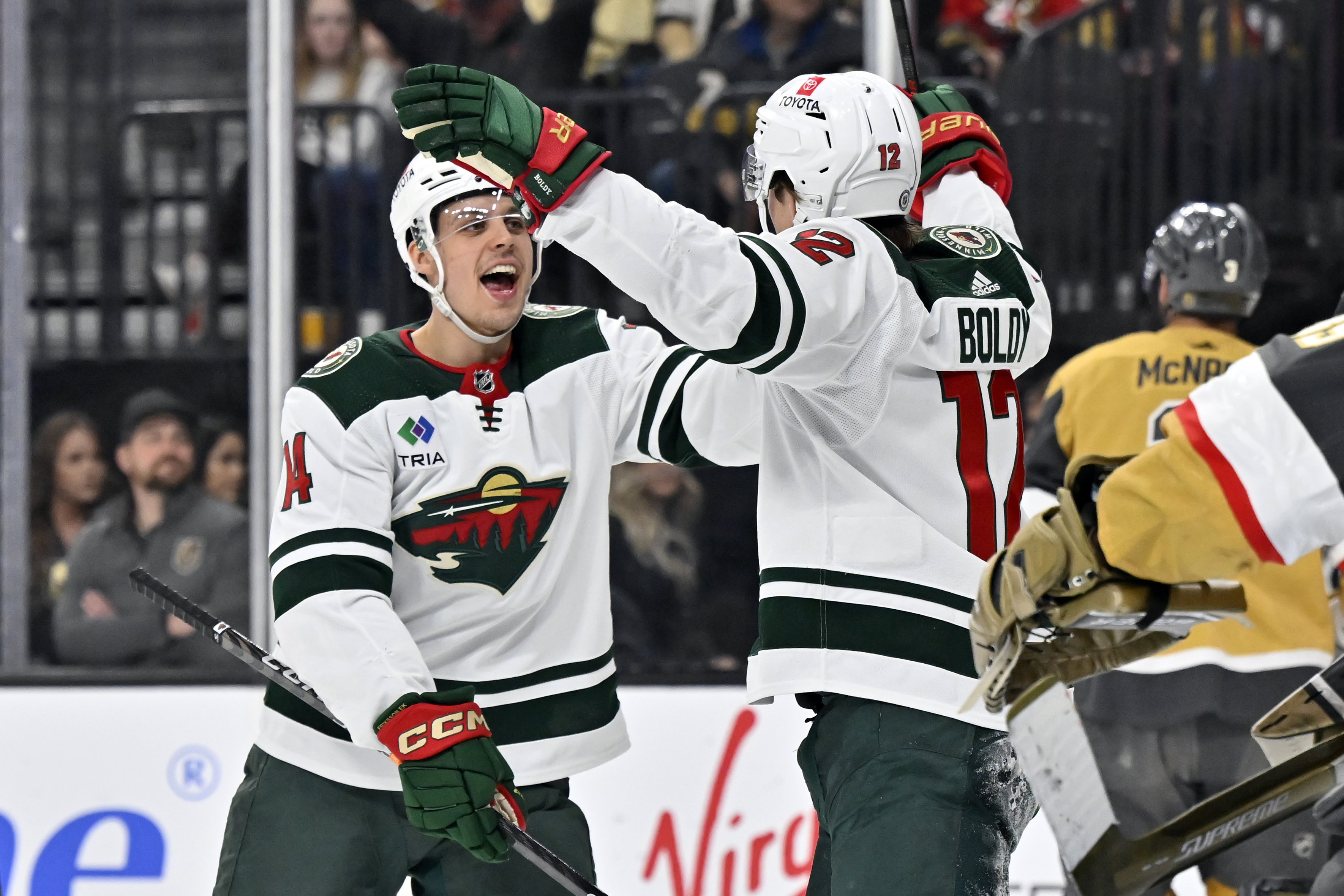 Minnesota Wild center Joel Eriksson Ek (14) and left wing Matt Boldy (12) reacts after a goal by Boldy against the Vegas Golden Knights during the first period of an NHL hockey game Saturday, April 1, 2023, in Las Vegas. 