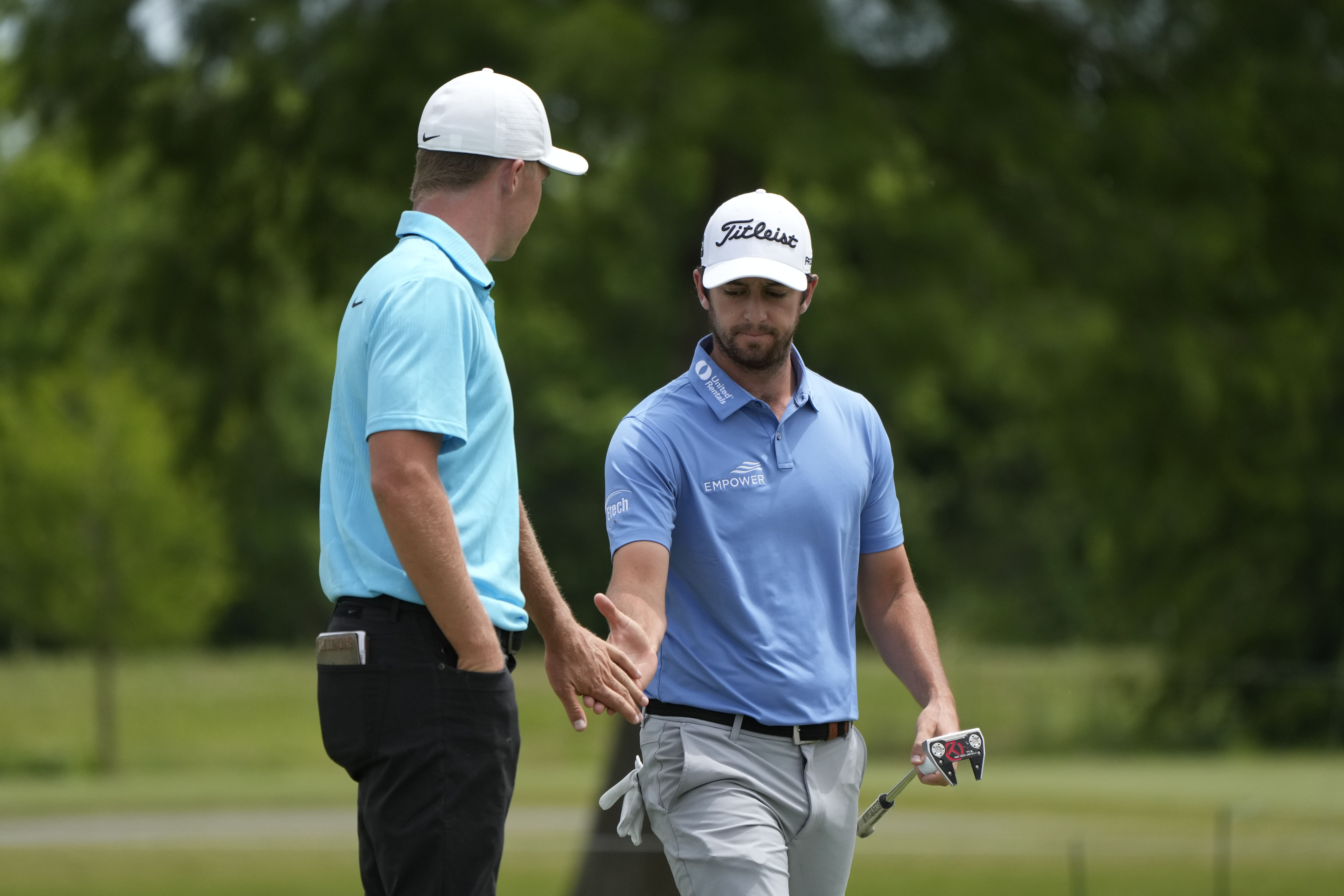 Davis Riley, right, greets his teammate Nick Hardy on the seventh green during the final round of the PGA Zurich Classic golf tournament at TPC Louisiana in Avondale, La., Sunday, April 23, 2023. 