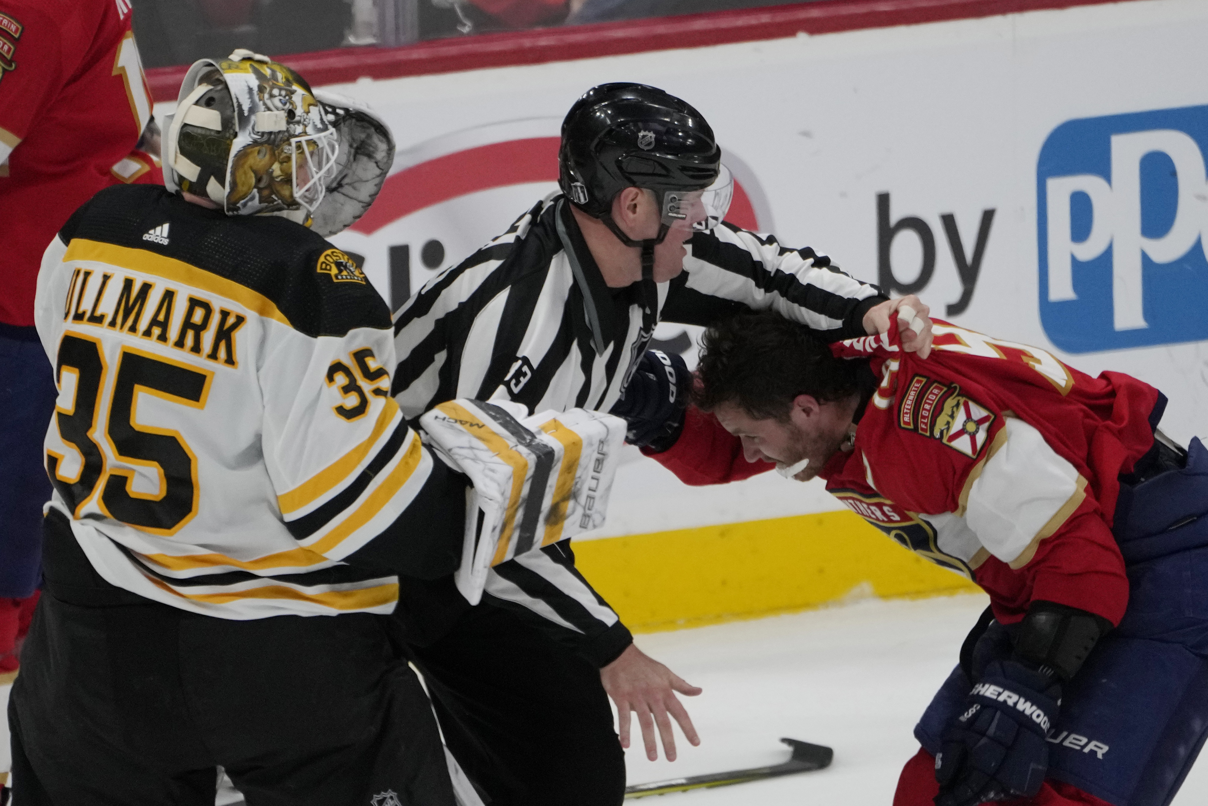 Florida Panthers left wing Matthew Tkachuk (19) his held back after exchanging punches with Boston Bruins goaltender Linus Ullmark (35) during the third period of Game 4 of an NHL hockey Stanley Cup first-round playoff series, Sunday, April 23, 2023, in Sunrise, Fla. 