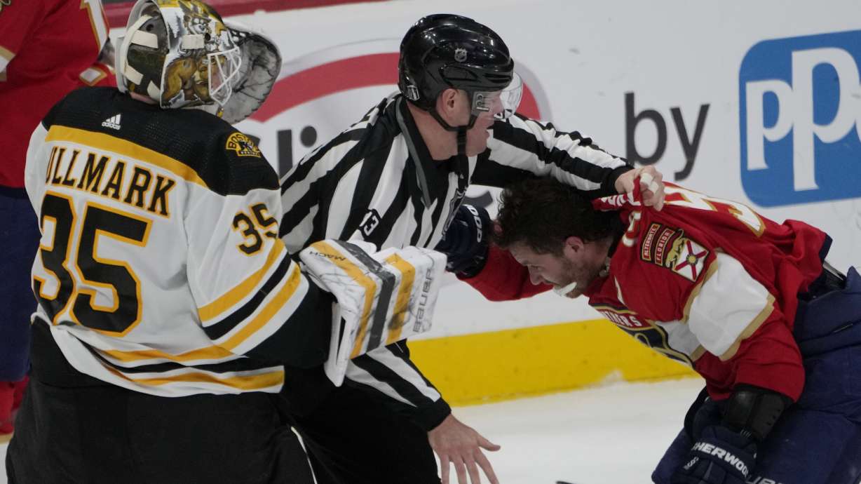 Florida Panthers left wing Matthew Tkachuk (19) his held back after exchanging punches with Boston Bruins goaltender Linus Ullmark (35) during the third period of Game 4 of an NHL hockey Stanley Cup first-round playoff series, Sunday, April 23, 2023, in Sunrise, Fla.