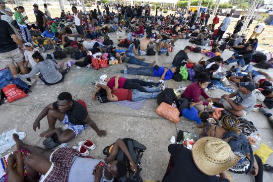 Migrants who are taking part in a caravan rest on the outskirts of Tapachula, Chiapas state, Mexico, Sunday. Migrants set out Sunday on what they call a mass protest procession through southern Mexico to demand the end of detention centers like the one that caught fire last month, killing 40 migrants.