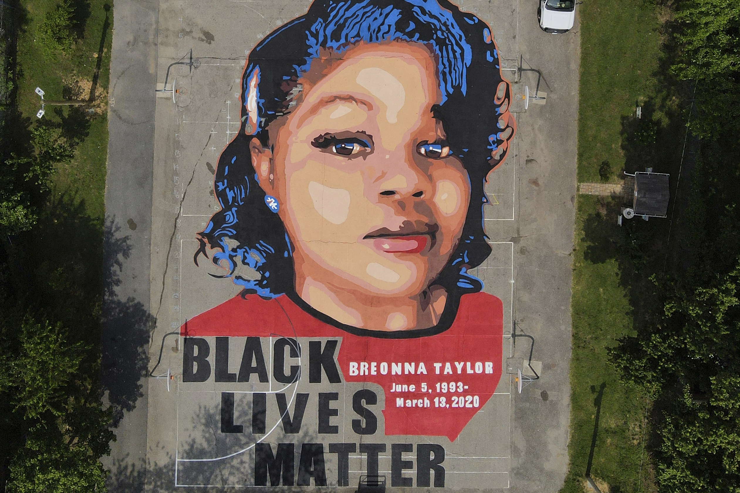 A ground mural depicting a portrait of Breonna Taylor is seen at Chambers Park in Annapolis, Md., July 6, 2020. The former Louisville Metro police officer who fatally shot Breonna Taylor has a new job in law enforcement. 
