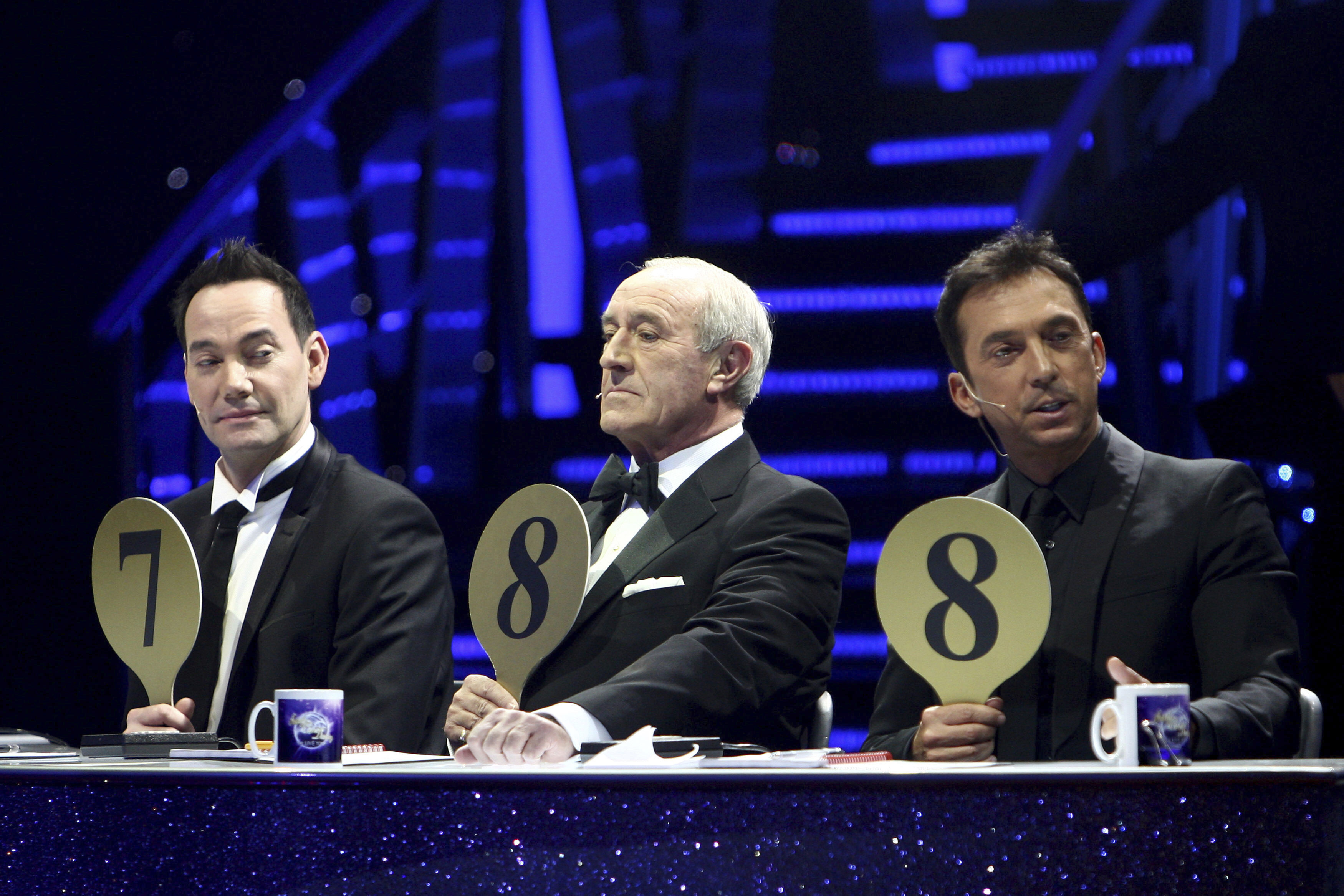 From left, judges Craig Revel Horwood, Len Goodman and Bruno Tonioli are seen during the 'Strictly Come Dancing Live Tour' at the NIA, Birmingham, England, Jan. 20, 2012. Len Goodman has died, his agent said Monday.