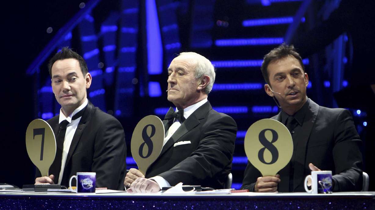 From left, judges Craig Revel Horwood, Len Goodman and Bruno Tonioli are seen during the 'Strictly Come Dancing Live Tour' at the NIA, Birmingham, England, Jan. 20, 2012. Len Goodman has died, his agent said Monday.