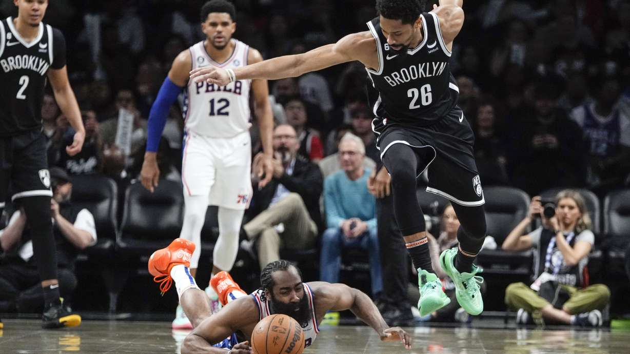 Philadelphia 76ers' James Harden, left, fights for control of the ball with Brooklyn Nets' Spencer Dinwiddie (26) during the second half of Game 4 in an NBA basketball first-round playoff series Saturday, April 22, 2023, in New York.