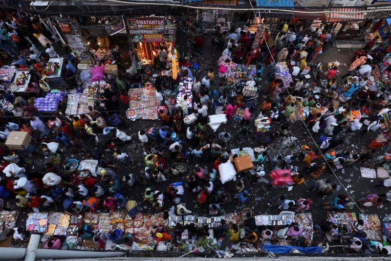 People shop at a crowded market in the old quarters of Delhi, India, Oct. 11, 2022. India is expected  to be the world's most populous country by the end of the month.