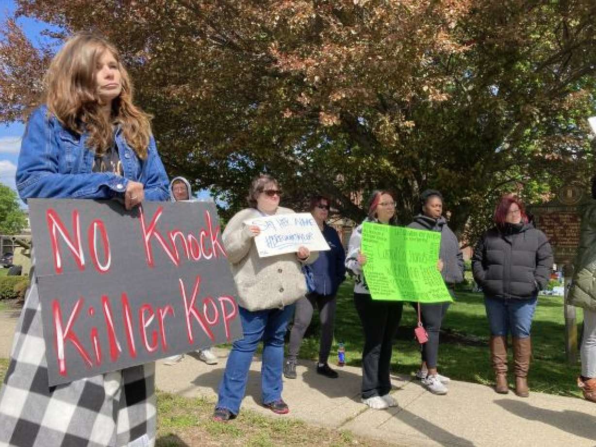 Protesters stand on a street corner in Carrollton, Ky. on Monday to protest the hiring of a former Louisville police officer who shot Breonna Taylor. Myles Cosgrove was recently hired by the Carroll County sheriff's department.