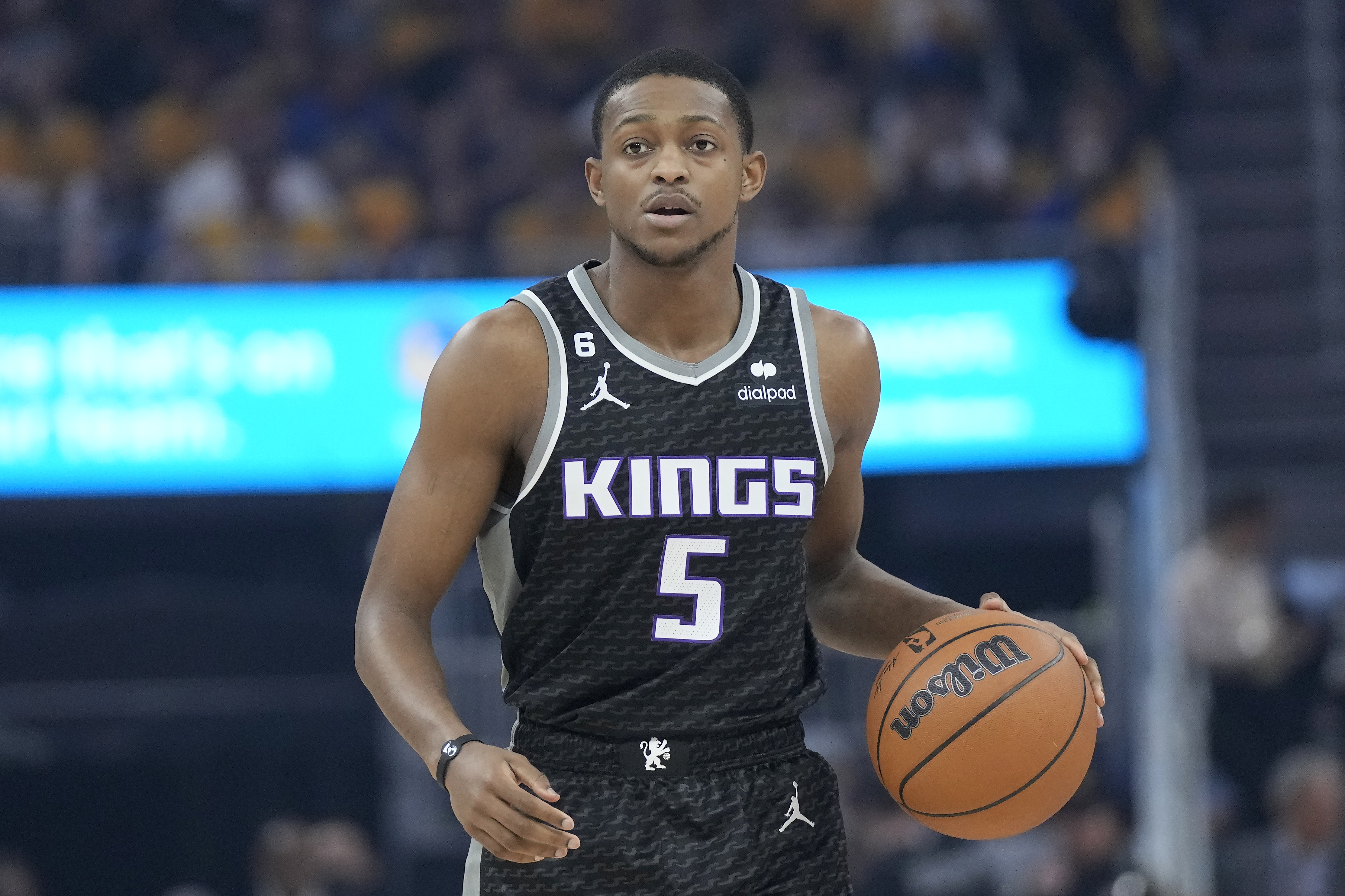 Sacramento Kings guard De'Aaron Fox (5) brings the ball upcourt against the Golden State Warriors during the first half of Game 4 in the first round of the NBA basketball playoffs in San Francisco, Sunday, April 23, 2023. 