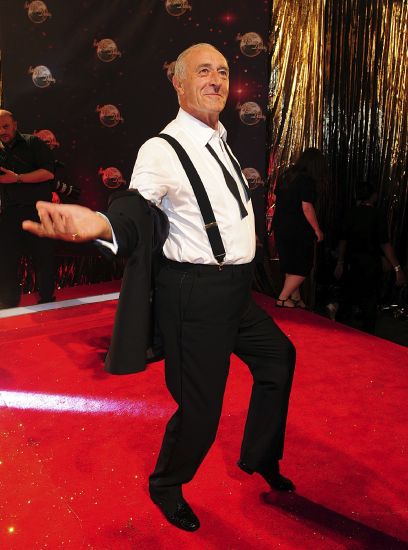Len Goodman poses as he arrives for the Strictly Come Dancing Photocall at Elstree Studios, London, Sept 3, 2013. The long-serving judge on “Dancing with the Stars” and “Strictly Come Dancing,” has died, his agent said Monday. He was 78.