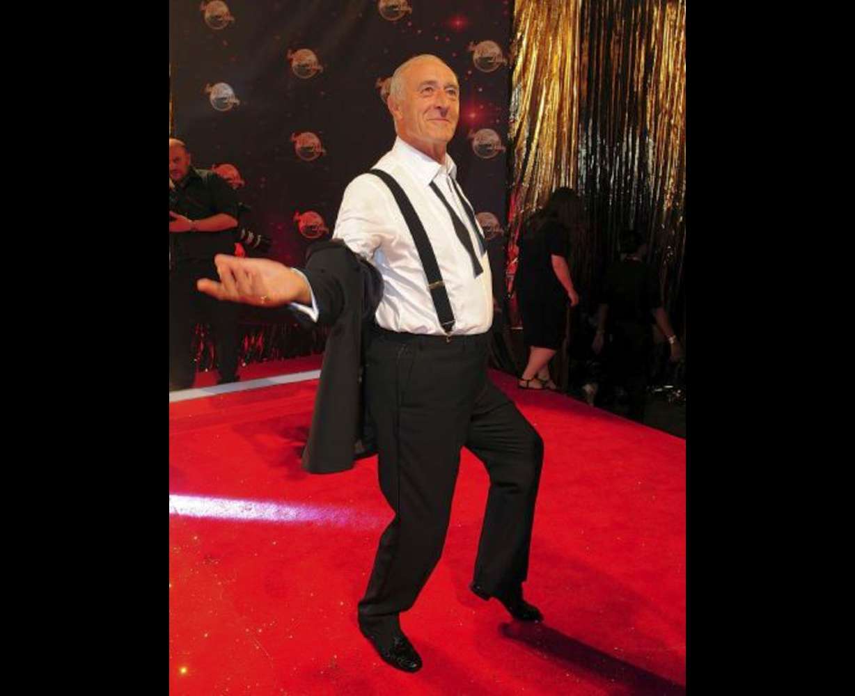 Len Goodman poses as he arrives for the Strictly Come Dancing Photocall at Elstree Studios, London, Sept 3, 2013. The long-serving judge on “Dancing with the Stars” and “Strictly Come Dancing,” has died, his agent said Monday. He was 78.