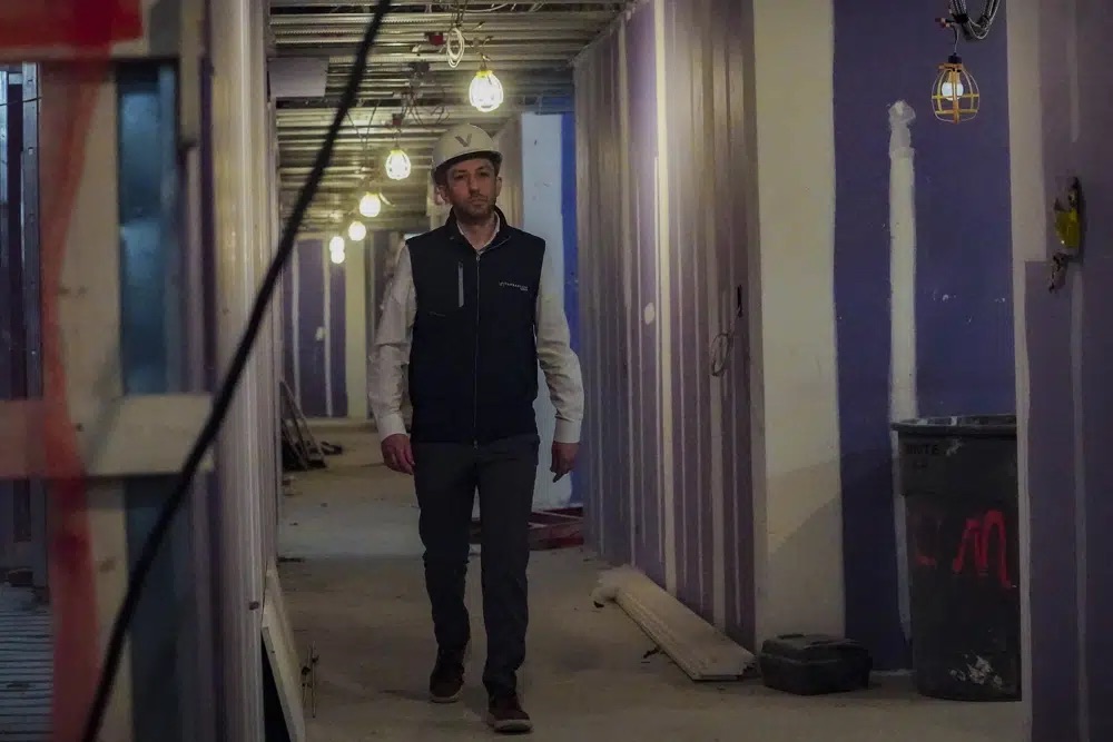 Joey Chilelli, managing director of real estate firm Vanbarton Group, heads for an interview inside his company's high rise in Manhattan's financial district, undergoing conversion from commercial to residential apartments, April 11 in New York.