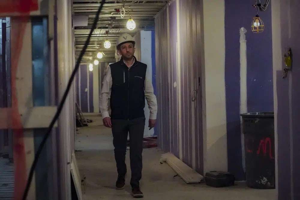 Joey Chilelli, managing director of real estate firm Vanbarton Group, heads for an interview inside his company's high rise in Manhattan's financial district, undergoing conversion from commercial to residential apartments, April 11 in New York.