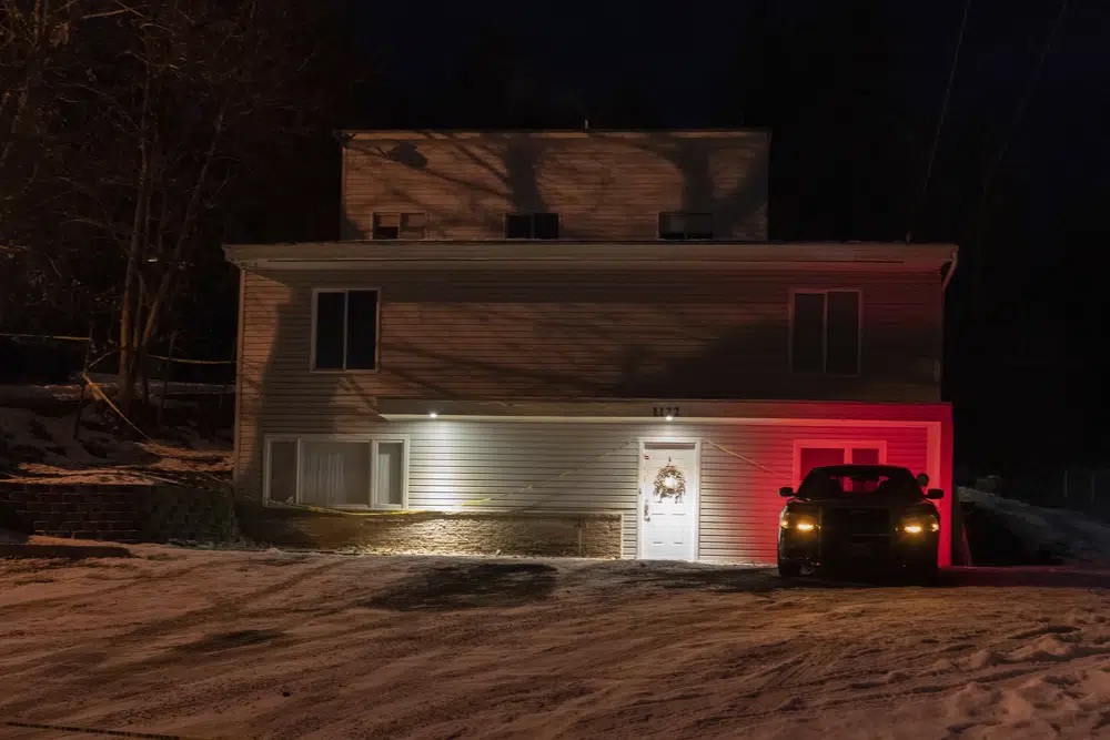 A private security officer sits in a vehicle on Jan. 3 in front of the house in Moscow, Idaho where four University of Idaho students were killed in November, 2022.