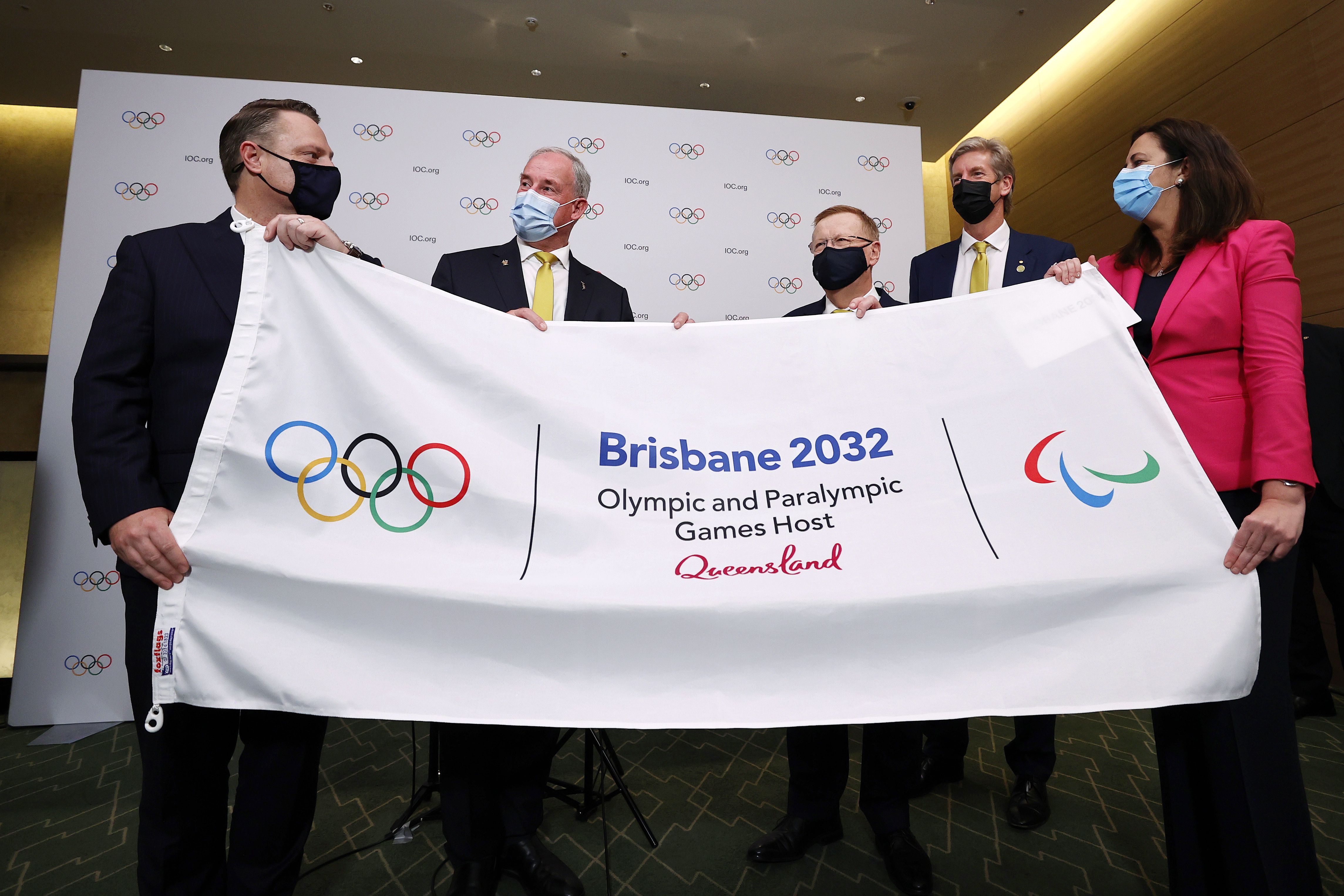 Lord Mayor of Brisbane,Adrian Schrinner, Richard Colbeck, John Coates, gold medalist James Tomkins and Annastacia Palaszczuk attend a press conference after Brisbane was announced as the 2032 Summer Olympics host city during the IOC Session at Hotel Okura in Tokyo, July 21, 2021.