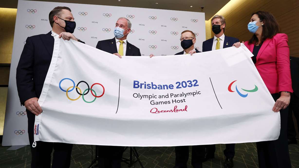 Lord Mayor of Brisbane,Adrian Schrinner, Richard Colbeck, John Coates, gold medalist James Tomkins and Annastacia Palaszczuk attend a press conference after Brisbane was announced as the 2032 Summer Olympics host city during the IOC Session at Hotel Okura in Tokyo, July 21, 2021.