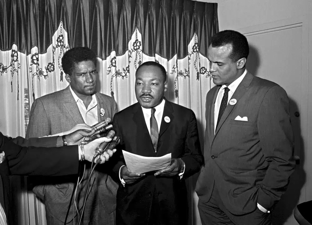 James Foreman, executive secretary of the Student Non-violent Coordinating Committee, left, civil rights leader Dr. Martin Luther King Jr., center, head of the Southern Christian Leadership Conference and activist-singer Harry Belafonte appear during a press conference in Atlanta on April 30, 1965. Belafonte died Tuesday of congestive heart failure at his New York home. He was 96.