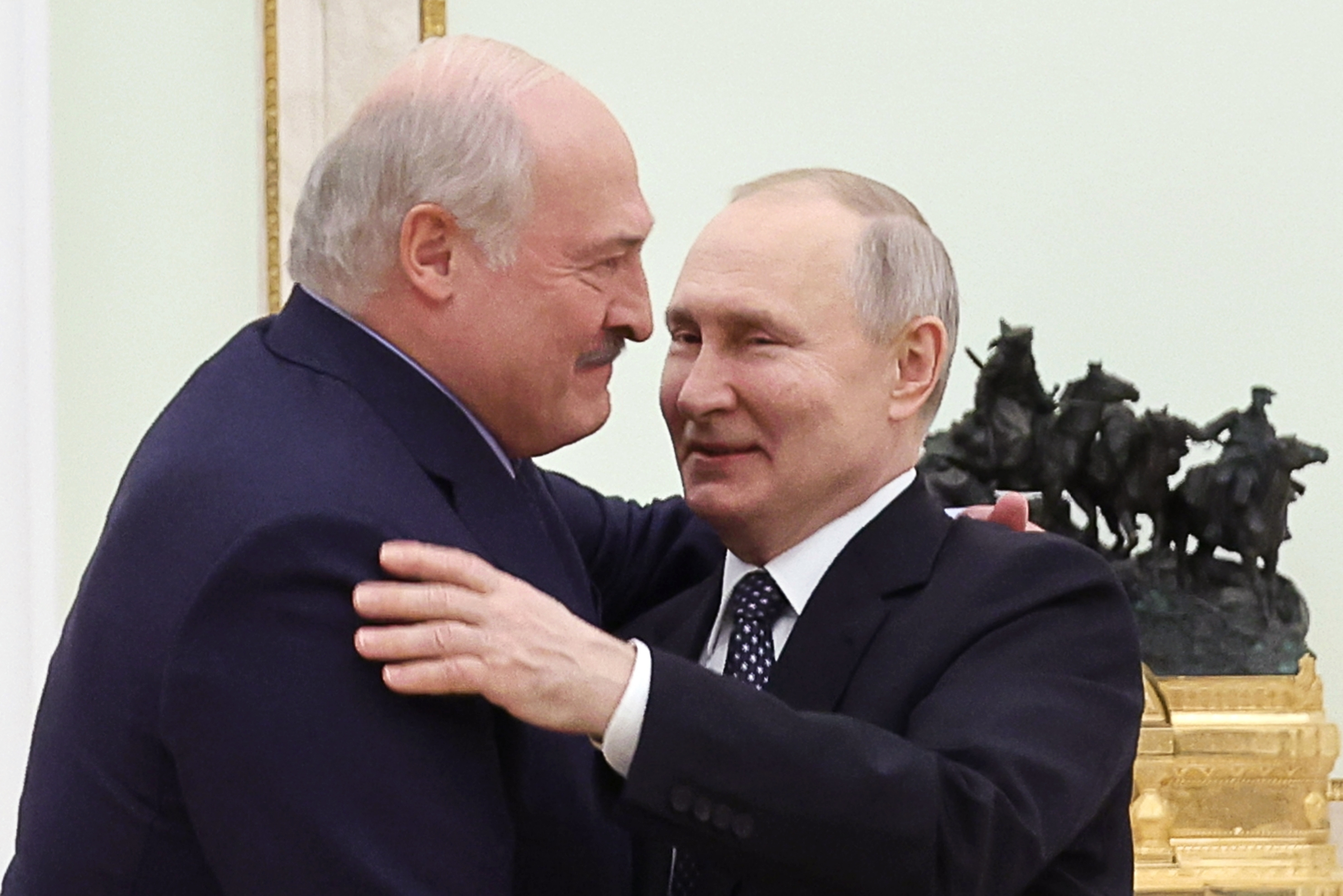 FILE - Belarusian President Alexander Lukashenko, left, and Russian President Vladimir Putin embrace each other during their meeting at the Kremlin in Moscow, Russia, Wednesday, April 5, 2023. Lukashenko has welcomed thousands of Russian troops to his country, allowed the Kremlin to use it to launch the invasion of Ukraine on Feb. 24, 2022, and offered to station some of Moscow’s tactical nuclear weapons there. But he has avoided having Belarus take part directly in the fighting – for now. 