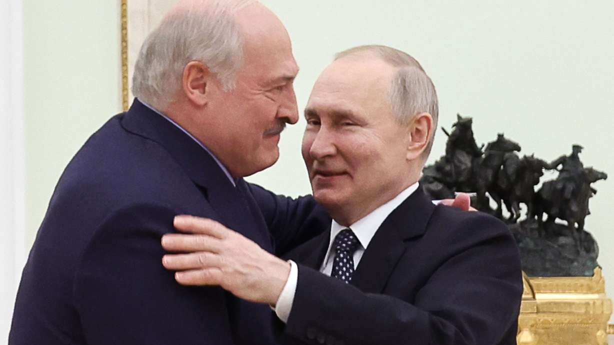 FILE - Belarusian President Alexander Lukashenko, left, and Russian President Vladimir Putin embrace each other during their meeting at the Kremlin in Moscow, Russia, Wednesday, April 5, 2023. Lukashenko has welcomed thousands of Russian troops to his country, allowed the Kremlin to use it to launch the invasion of Ukraine on Feb. 24, 2022, and offered to station some of Moscow’s tactical nuclear weapons there. But he has avoided having Belarus take part directly in the fighting – for now.