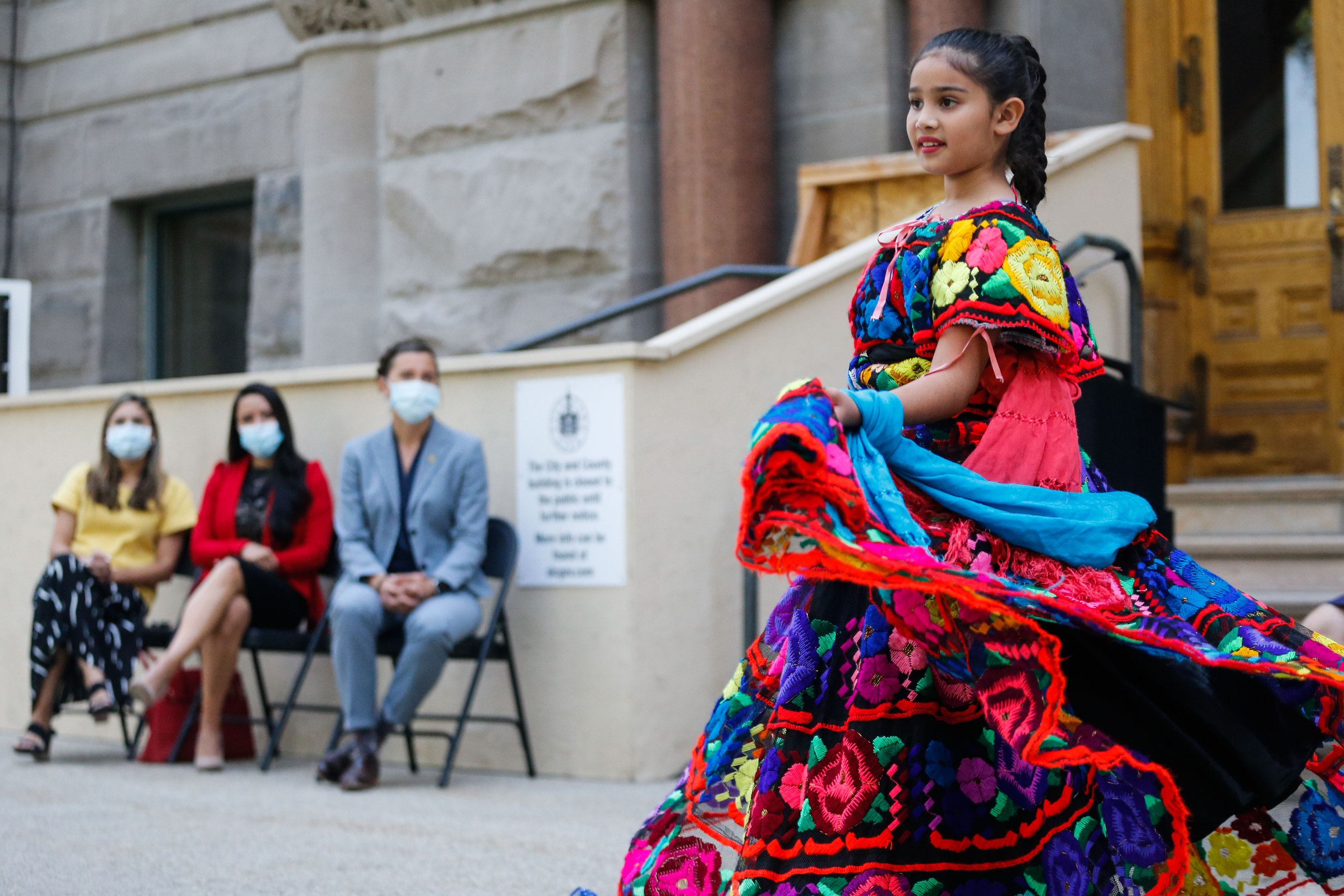 Mili Silos, 11, performs a traditional ballet folklorico as Salt Lake City Mayor Erin Mendenhall and leaders from Latino and Hispanic communities watch on Sept. 15, 2021, in Salt Lake City. A Día de los Niños event this weekend is geared toward connecting Latino families with health resources.