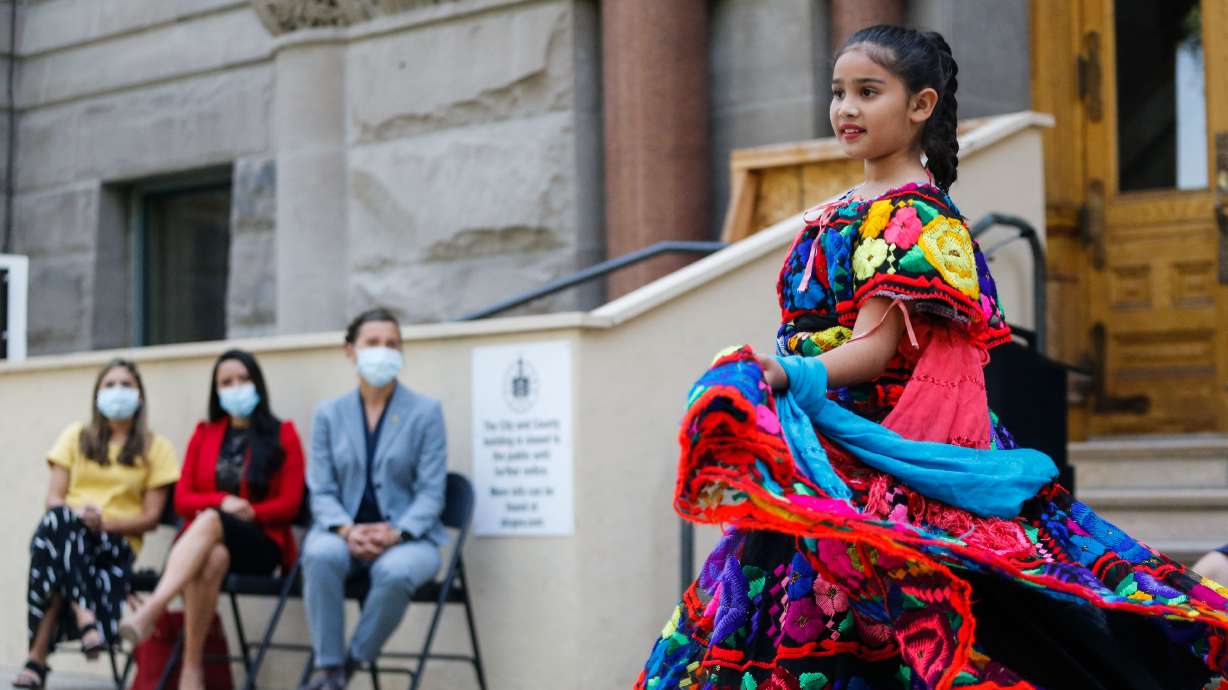 Mili Silos, 11, performs a traditional ballet folklorico as Salt Lake City Mayor Erin Mendenhall and leaders from Latino and Hispanic communities watch on Sept. 15, 2021, in Salt Lake City. A Día de los Niños event this weekend is geared toward connecting Latino families with health resources.