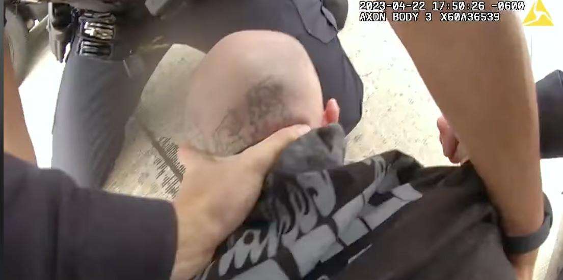 Shawn D Lane Sims, 30, is seen on police body camera video as Ogden police tackle and try to restrain him in Ogden on Saturday.