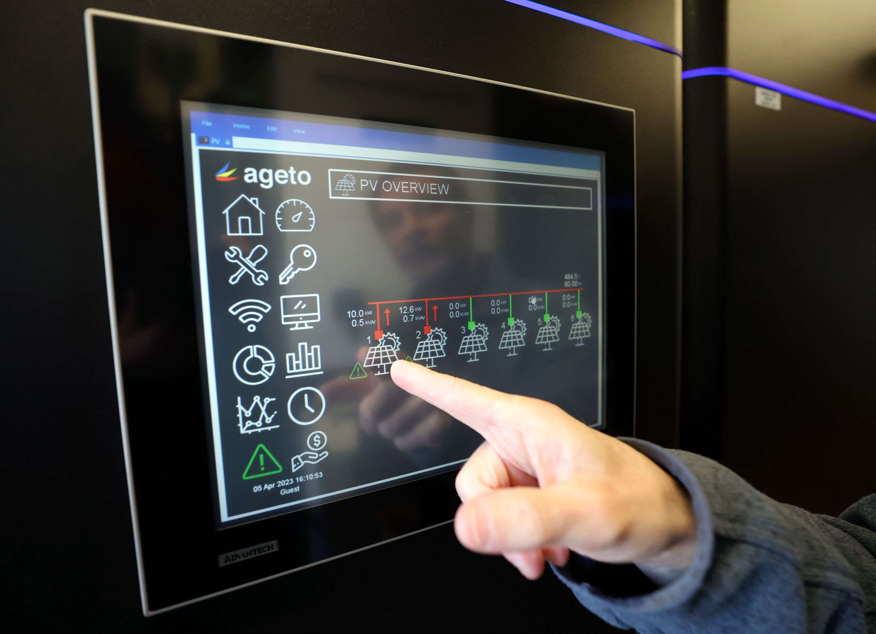 Kurt Myers, Idaho National Laboratory distributed energy and grid systems integration group lead, shows current microgrid solar performance in a portable shipping container that houses battery storage outside of the INL Energy Systems Laboratory in Idaho Falls, Idaho, on April 5.