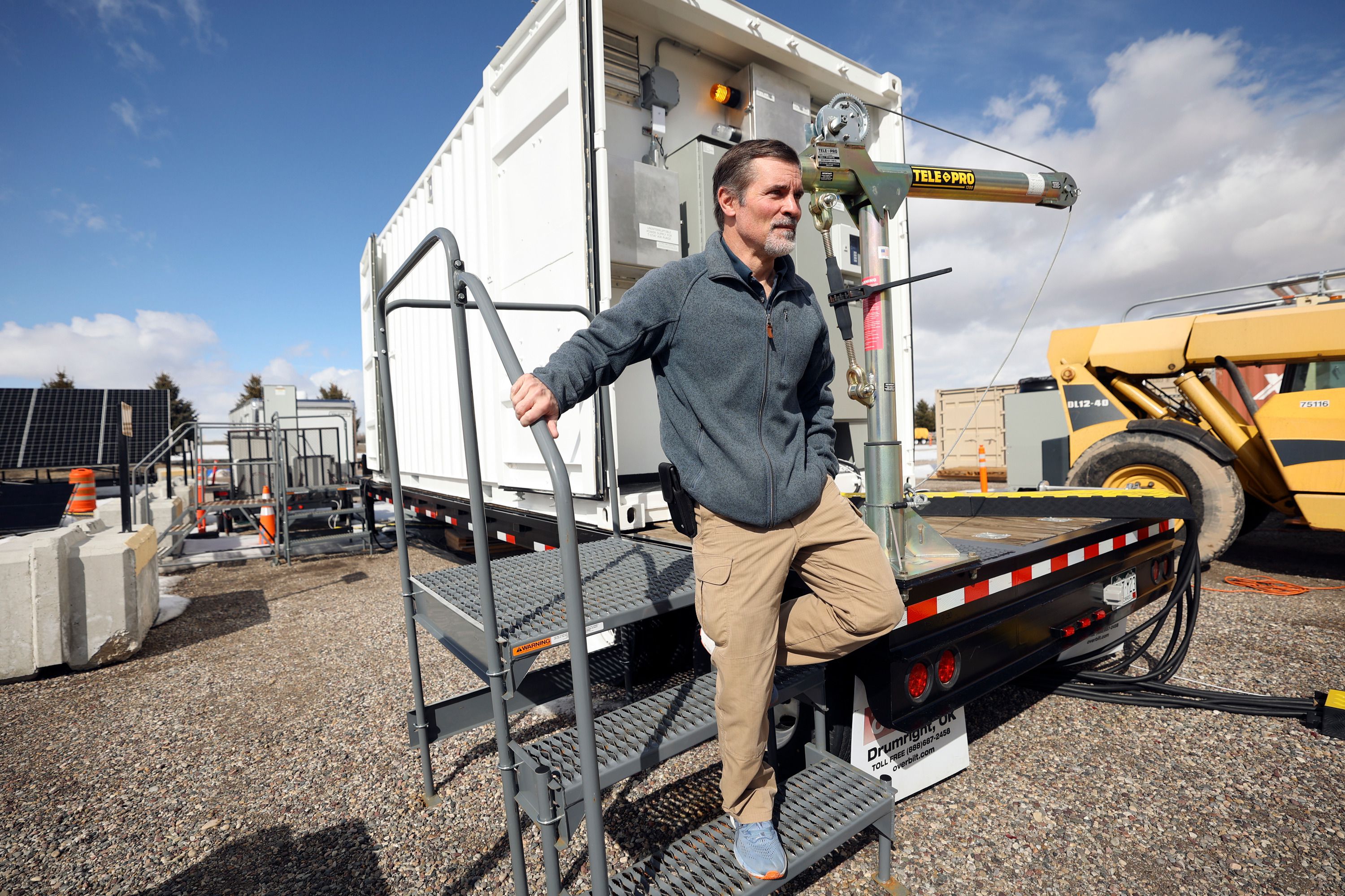 Kurt Myers, Idaho National Laboratory distributed energy and grid systems integration group lead, walks away from a portable shipping container that is part of a microgrid, connected to solar panels, after checking a meter on it outside of the INL Energy Systems Laboratory in Idaho Falls, Idaho, on April 5.