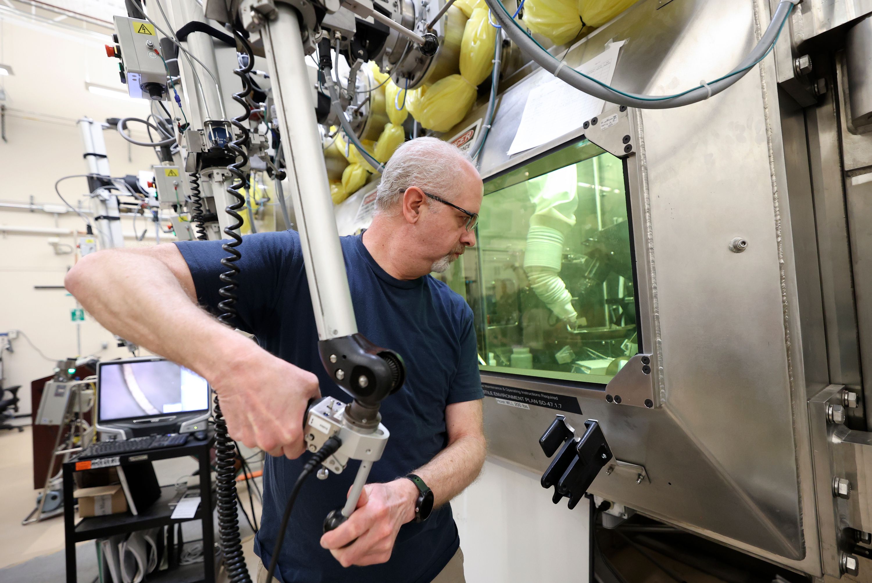 Scott Anderson, researcher, prepares samples in a hot cell in the Materials and Fuels Complex at the Idaho National Laboratory in Atomic City, Idaho, on April 5.