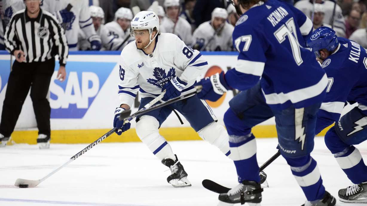 Toronto Maple Leafs right wing William Nylander (88) carries the puck around Tampa Bay Lightning defenseman Victor Hedman (77) and left wing Alex Killorn (17) during the first period in Game 4 of an NHL hockey Stanley Cup first-round playoff series Monday, April 24, 2023, in Tampa, Fla.