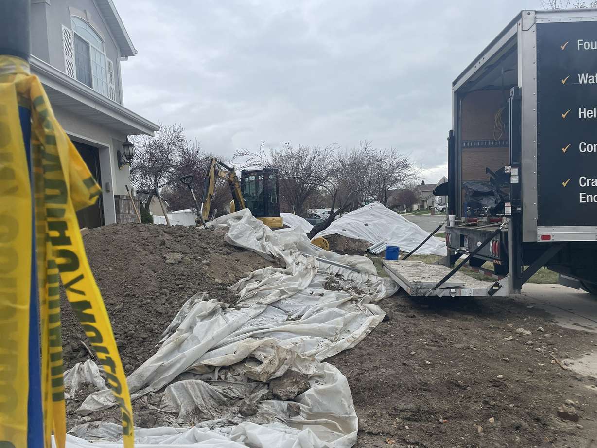 Bryan Bradbury's home in Woods Cross is under repair Tuesday after it has been sinking.