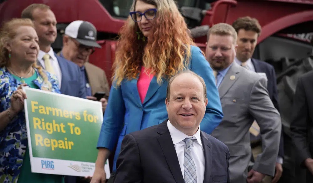 Colorado Gov. Jared Polis signs legislation Tuesday in Denver that forces manufacturers to provide the necessary equipment to farmers so they can fix their own machines.