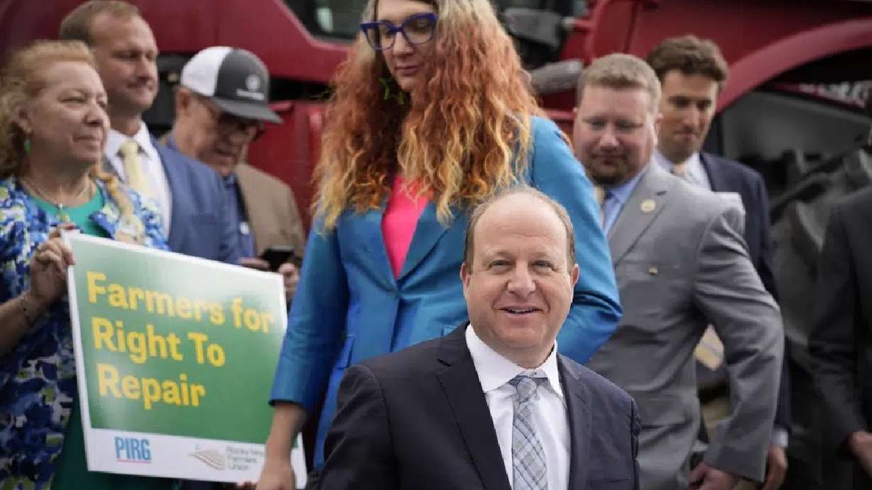Colorado Gov. Jared Polis signs legislation Tuesday in Denver that forces manufacturers to provide the necessary equipment to farmers so they can fix their own machines.