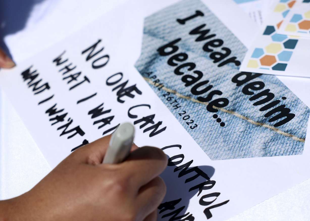 Event attendees fill out signs explaining why they wear denim at the Utah Coalition Against Sexual Assault’s Denim Day press conference at the Capitol in Salt Lake City on Wednesday. Denim Day started in 1999 and is the world’s largest and longest-running sexual assault awareness and education campaign.
