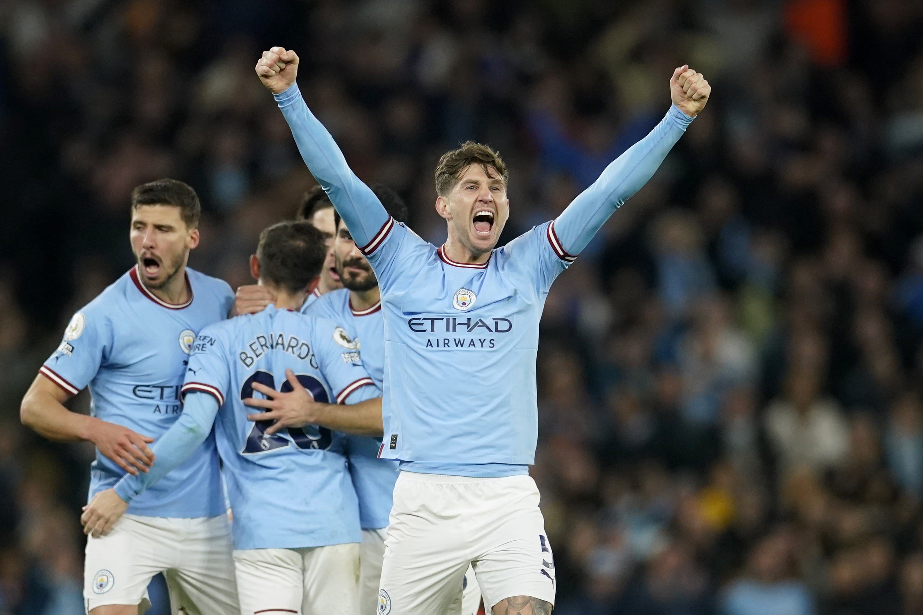 Manchester City's John Stones, right, celebrates after scoring his side's second goal during the English Premier League soccer match between Manchester City and Arsenal at Etihad stadium in Manchester, England, Wednesday, April 26, 2023.