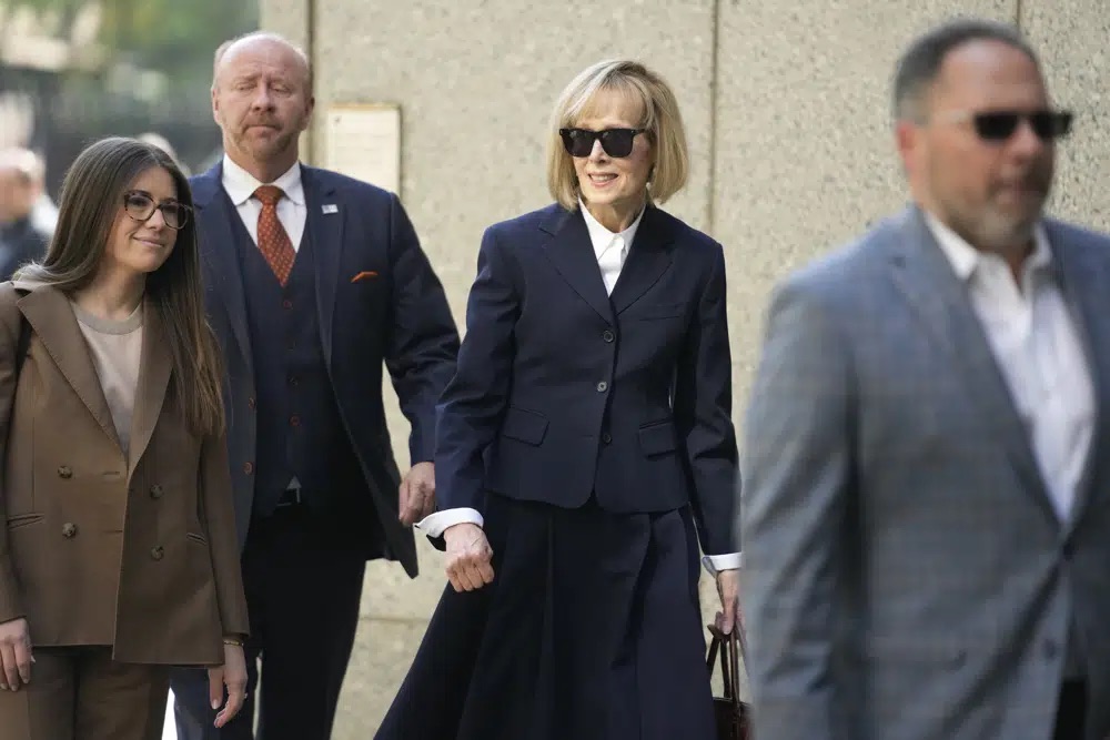 Former advice columnist E. Jean Carroll, second from right, arrives to federal court in New York, Wednesday. Jurors have been seated in the trial over Carroll's claim that former President Donald Trump raped her nearly three decades ago in a department store dressing room.