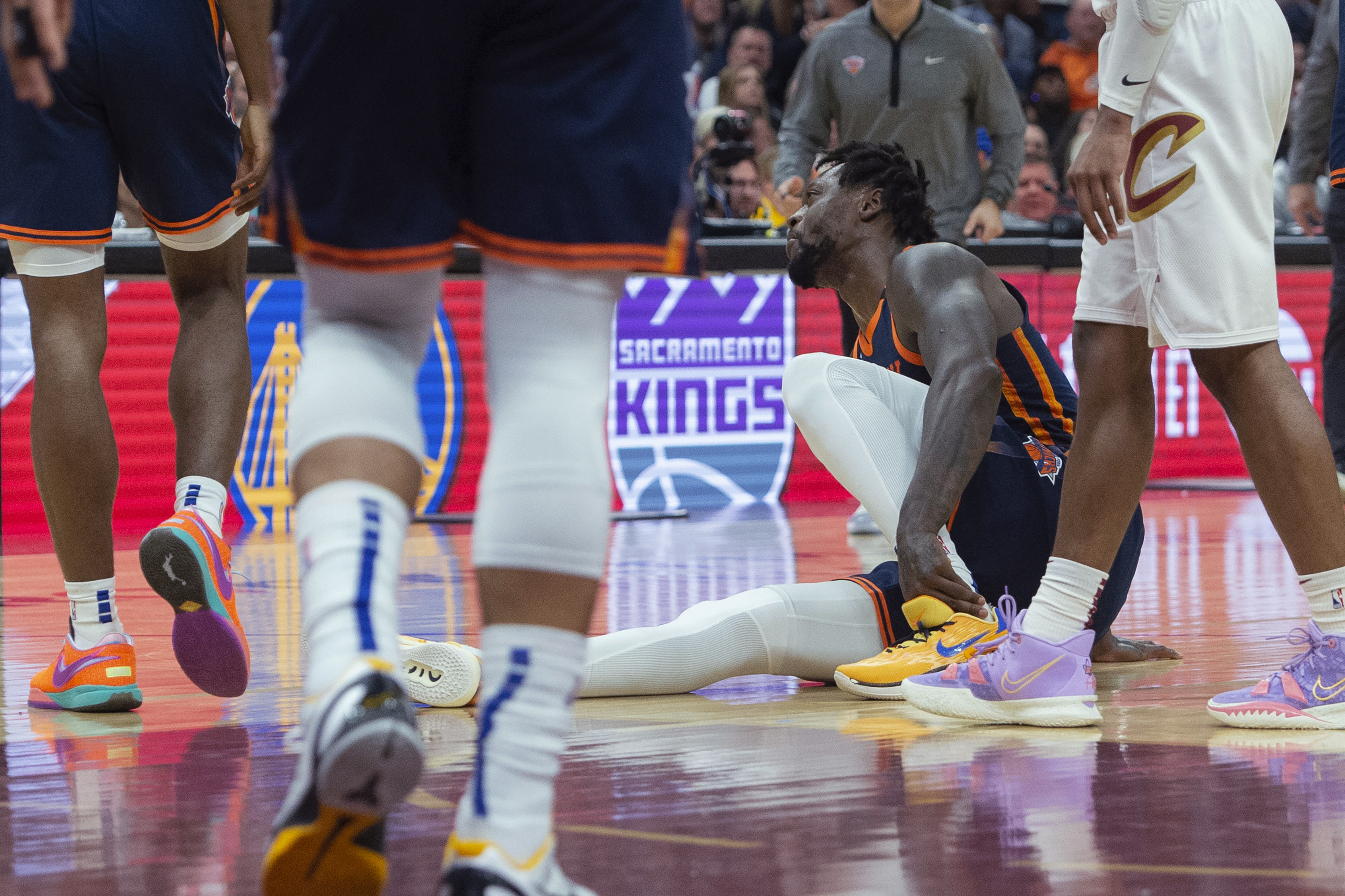 New York Knicks' Julius Randle (30) grabs his ankle during the first half of Game 5 of the team's NBA basketball first-round playoff series against the Cleveland Cavaliers, Wednesday, April 26, 2023, in Cleveland.