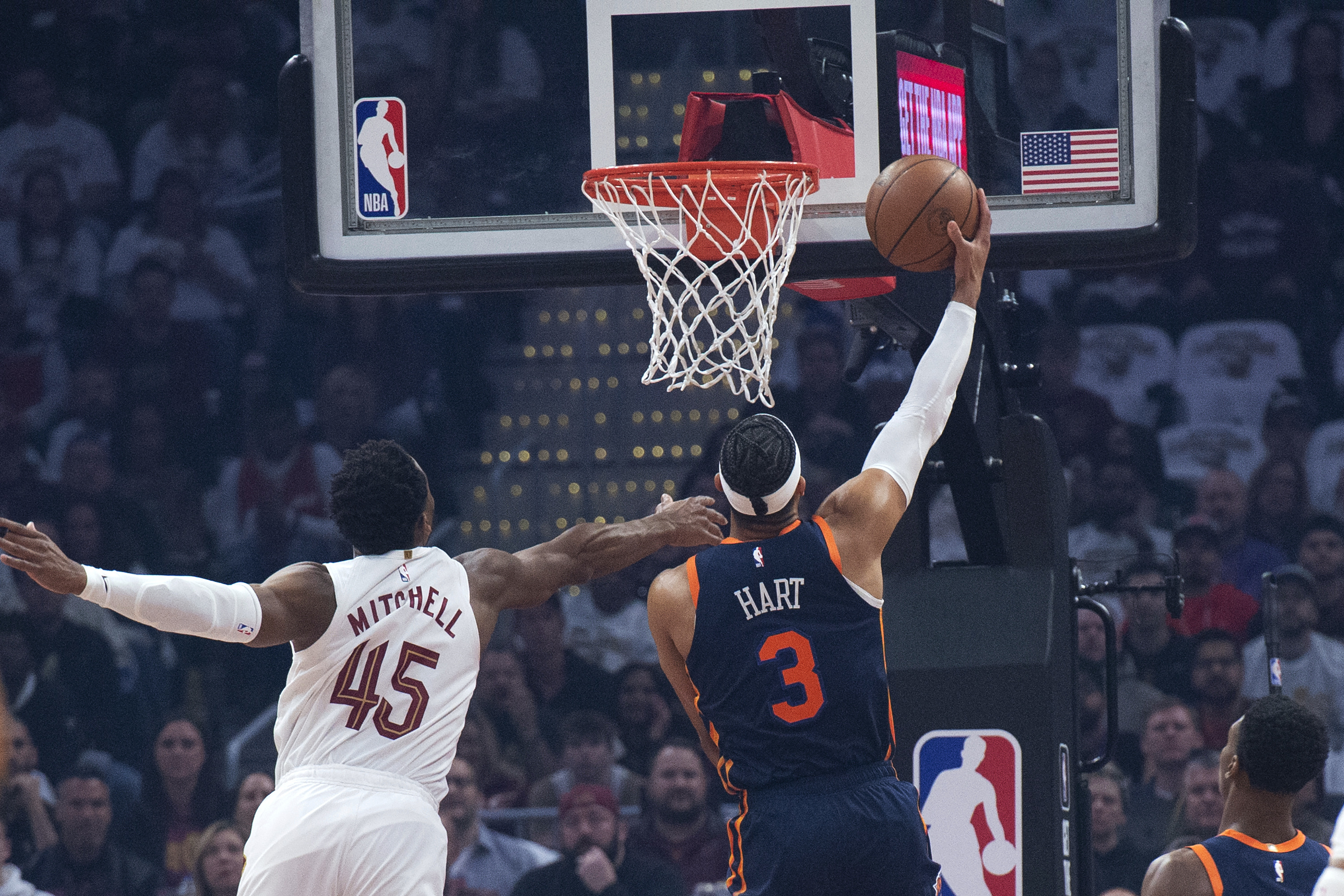 New York Knicks' Josh Hart (3) makes a layup past Cleveland Cavaliers' Donovan Mitchell (45) during the first half of Game 5 of an NBA basketball first-round playoff series Wednesday, April 26, 2023, in Cleveland.