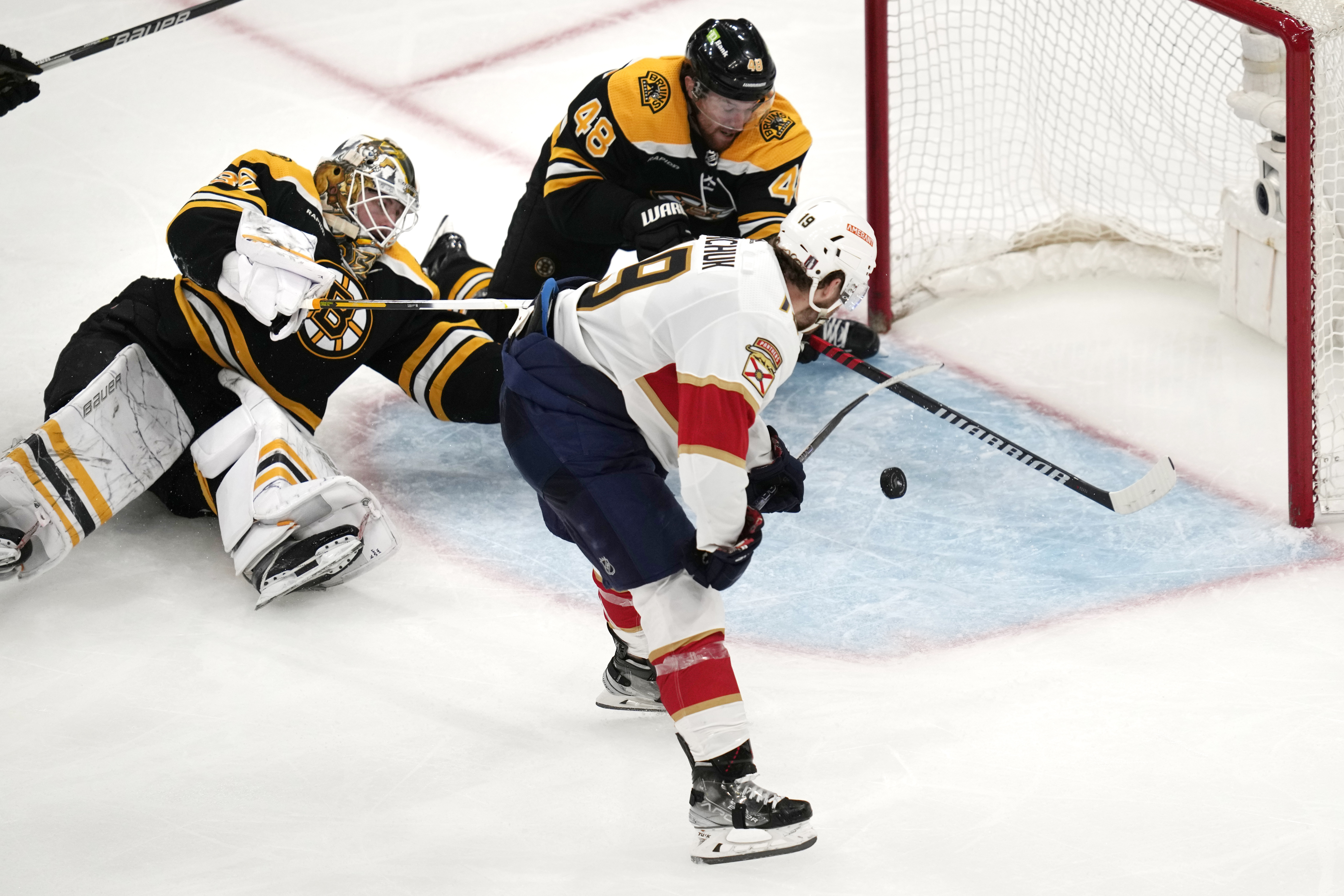 Florida Panthers left wing Matthew Tkachuk (19) shoots the puck past Boston Bruins goaltender Linus Ullmark and defenseman Matt Grzelcyk (48) while scoring the game-winning goal during overtime of Game 5 in the first round of the NHL hockey playoffs, Wednesday, April 26, 2023, in Boston. 