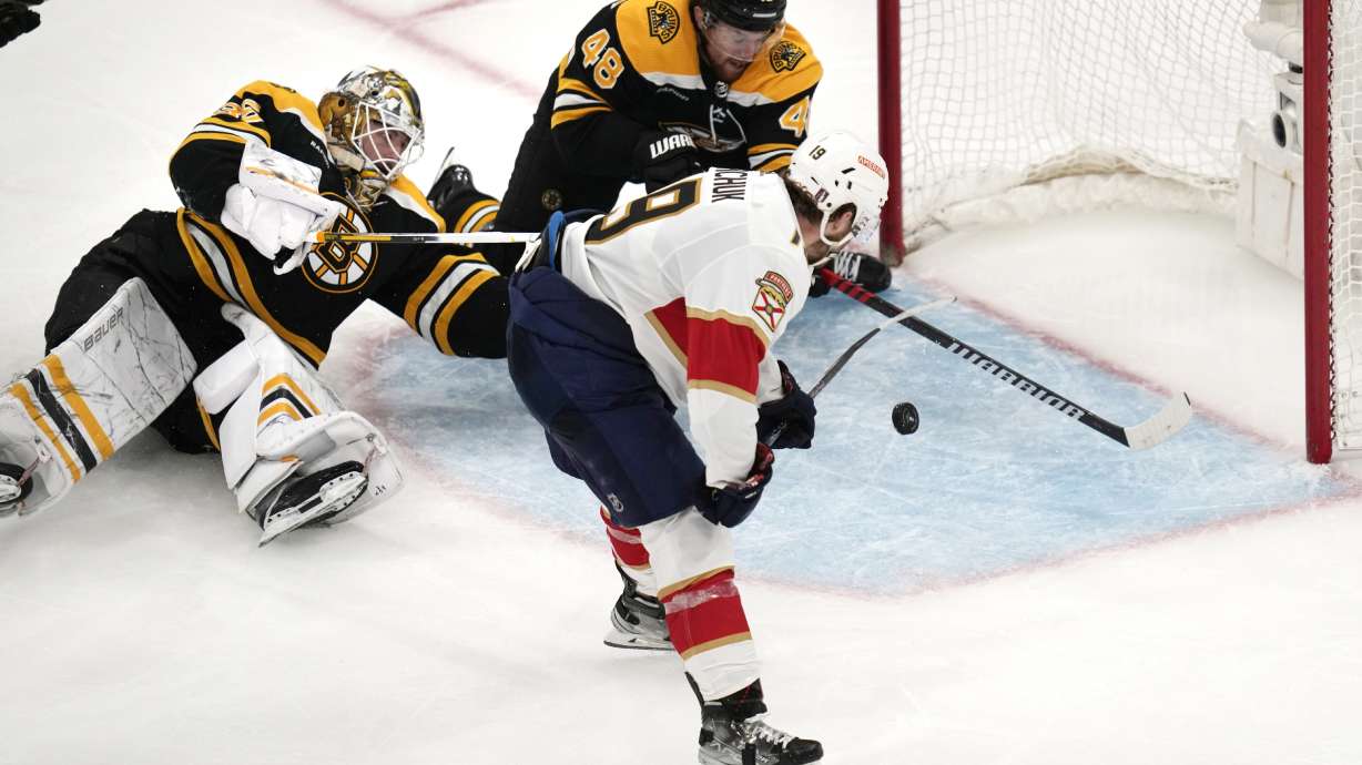Florida Panthers left wing Matthew Tkachuk (19) shoots the puck past Boston Bruins goaltender Linus Ullmark and defenseman Matt Grzelcyk (48) while scoring the game-winning goal during overtime of Game 5 in the first round of the NHL hockey playoffs, Wednesday, April 26, 2023, in Boston.