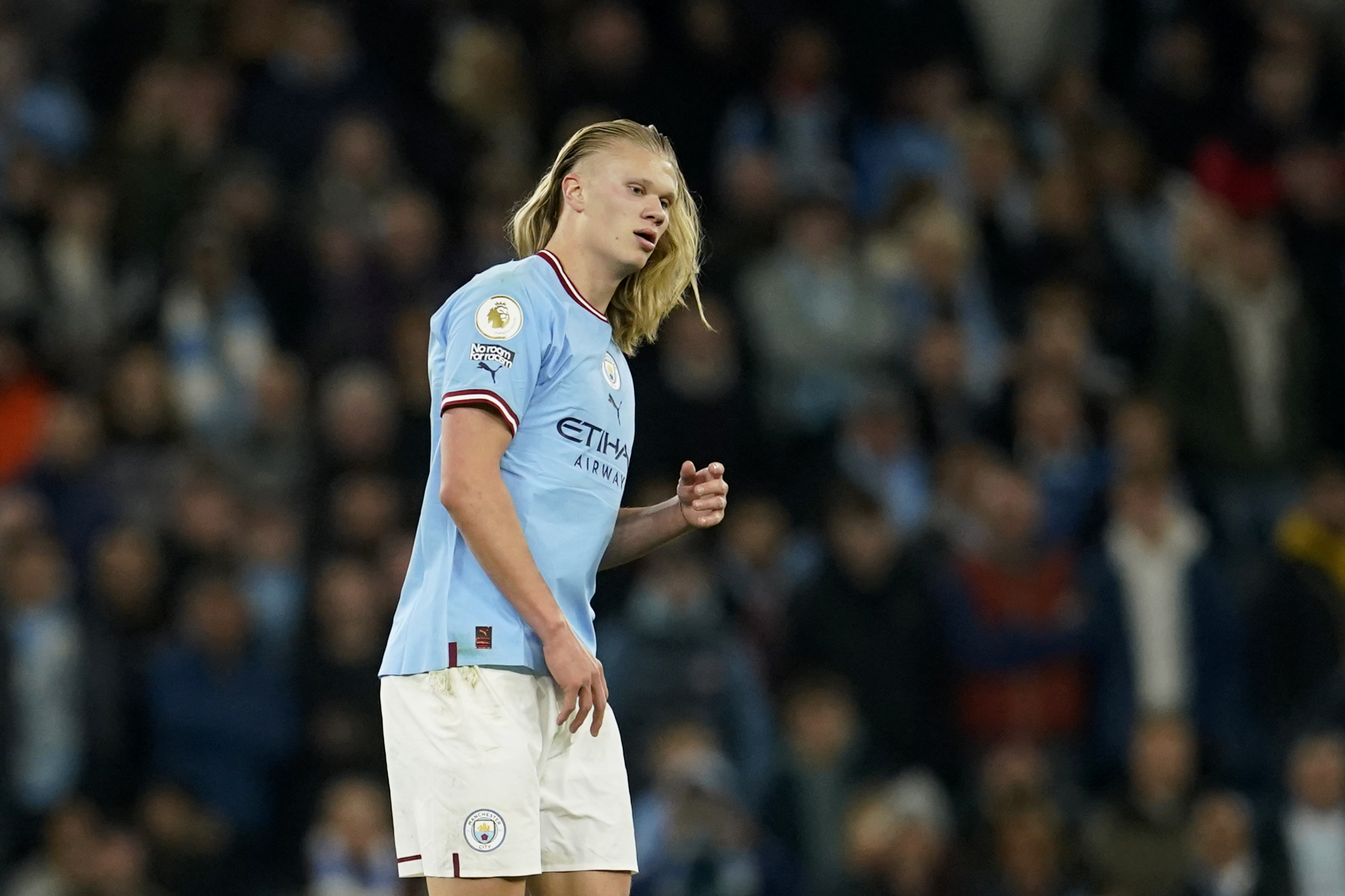 Manchester City's Erling Haaland lets his hair loose during the English Premier League soccer match between Manchester City and Arsenal at Etihad stadium in Manchester, England, Wednesday, April 26, 2023. 