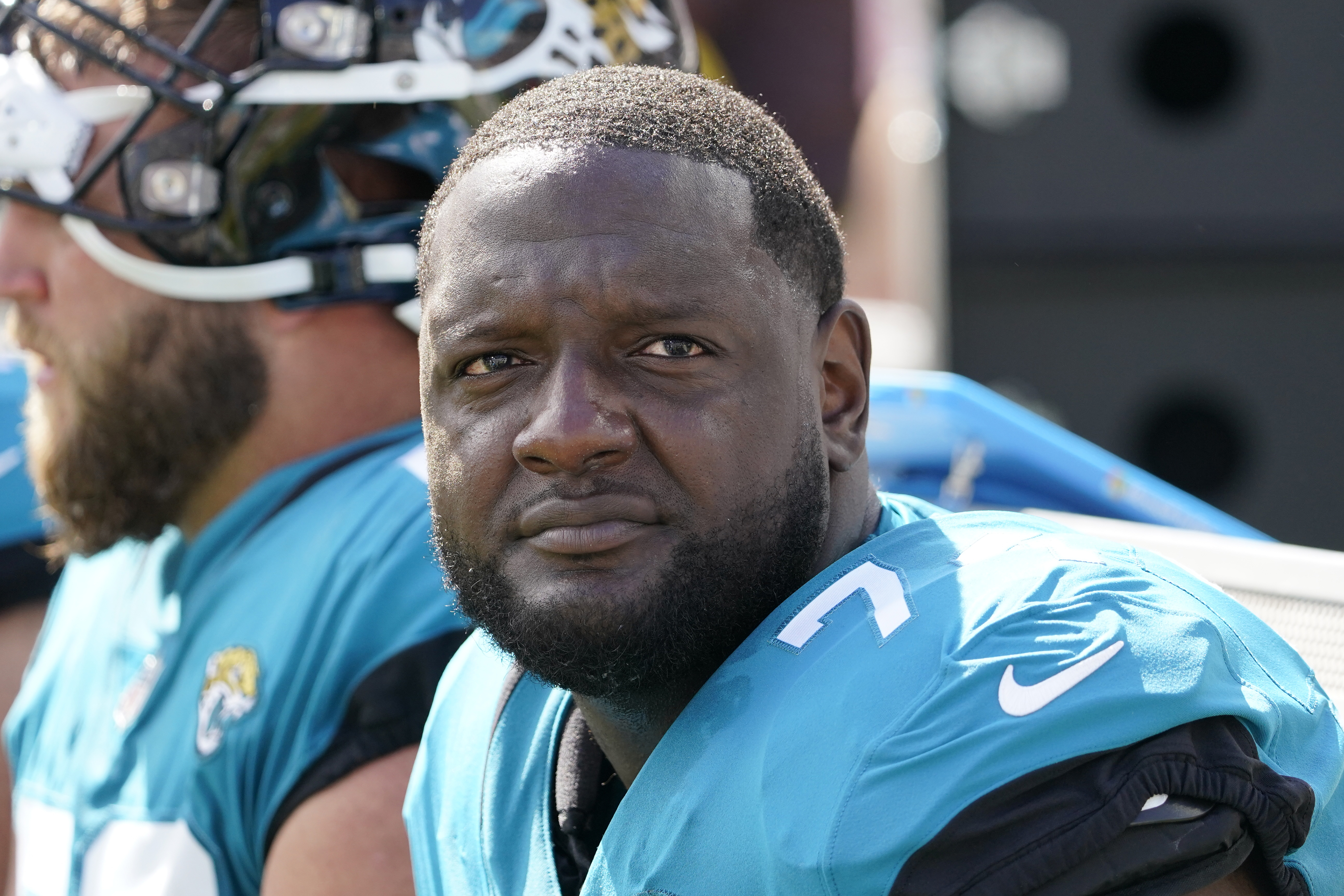 FILE - Jacksonville Jaguars offensive tackle Cam Robinson (74) watches play against the New York Giants during the first half of an NFL football game Sunday, Oct. 23, 2022, in Jacksonville, Fla. A person familiar with the situation says Jacksonville Jaguars left tackle Cam Robinson is facing a multigame suspension for violating the NFL's policy on performance-enhancing drugs. The person spoke to The Associated Press on condition of anonymity Thursday, April 27, 2023, because the suspension has not been announced and is pending the result of a B sample. 