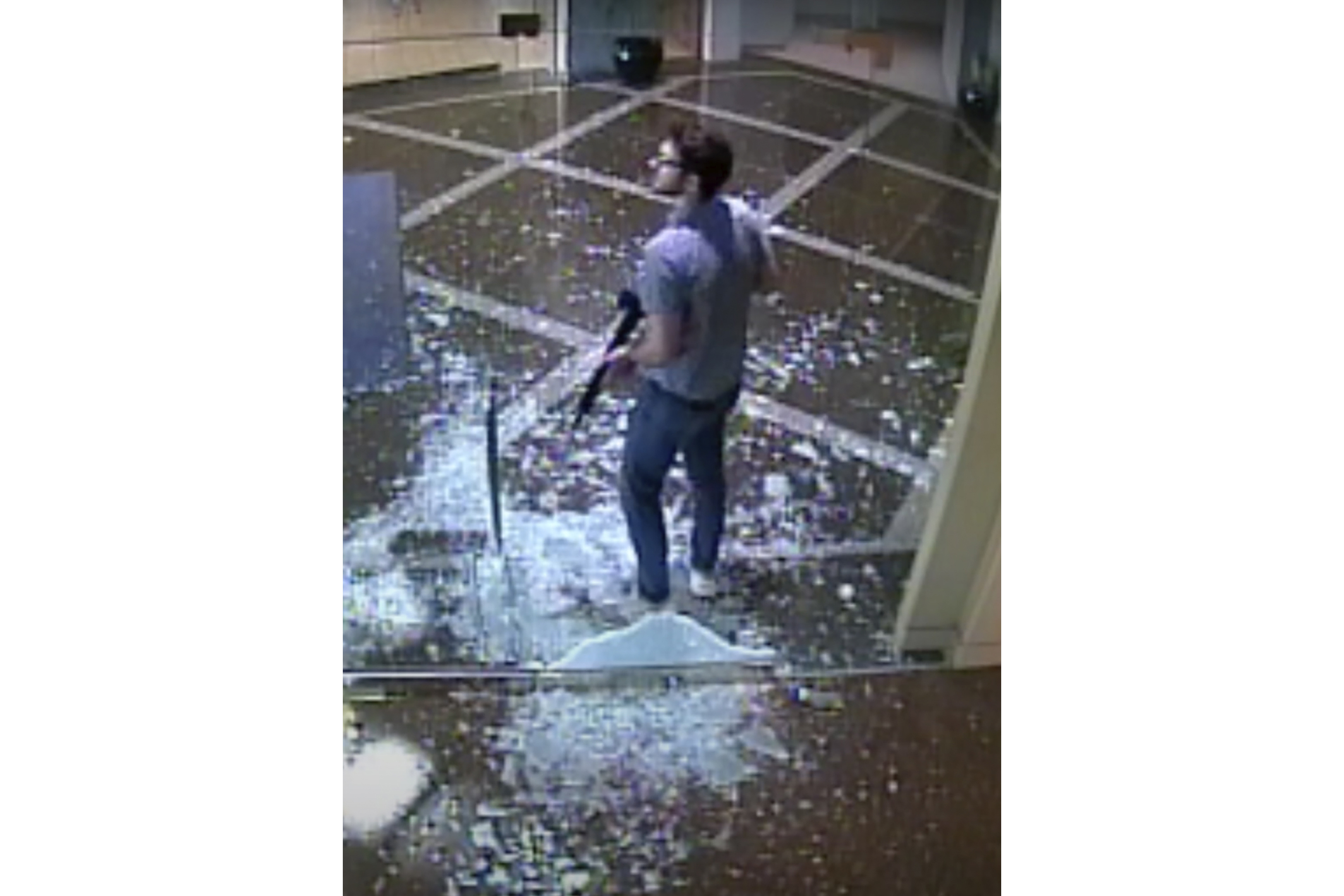 This image taken from surveillance video shows bank employee Connor Sturgeon, 25, carrying an AR-15 assault-style rifle after opening fire at Old National Bank, in Louisville, Ky., on April 10. Sturgeon had confronted mental health problems over the last year and the situation appeared to be managed until just days before the shooting, his mother said.
