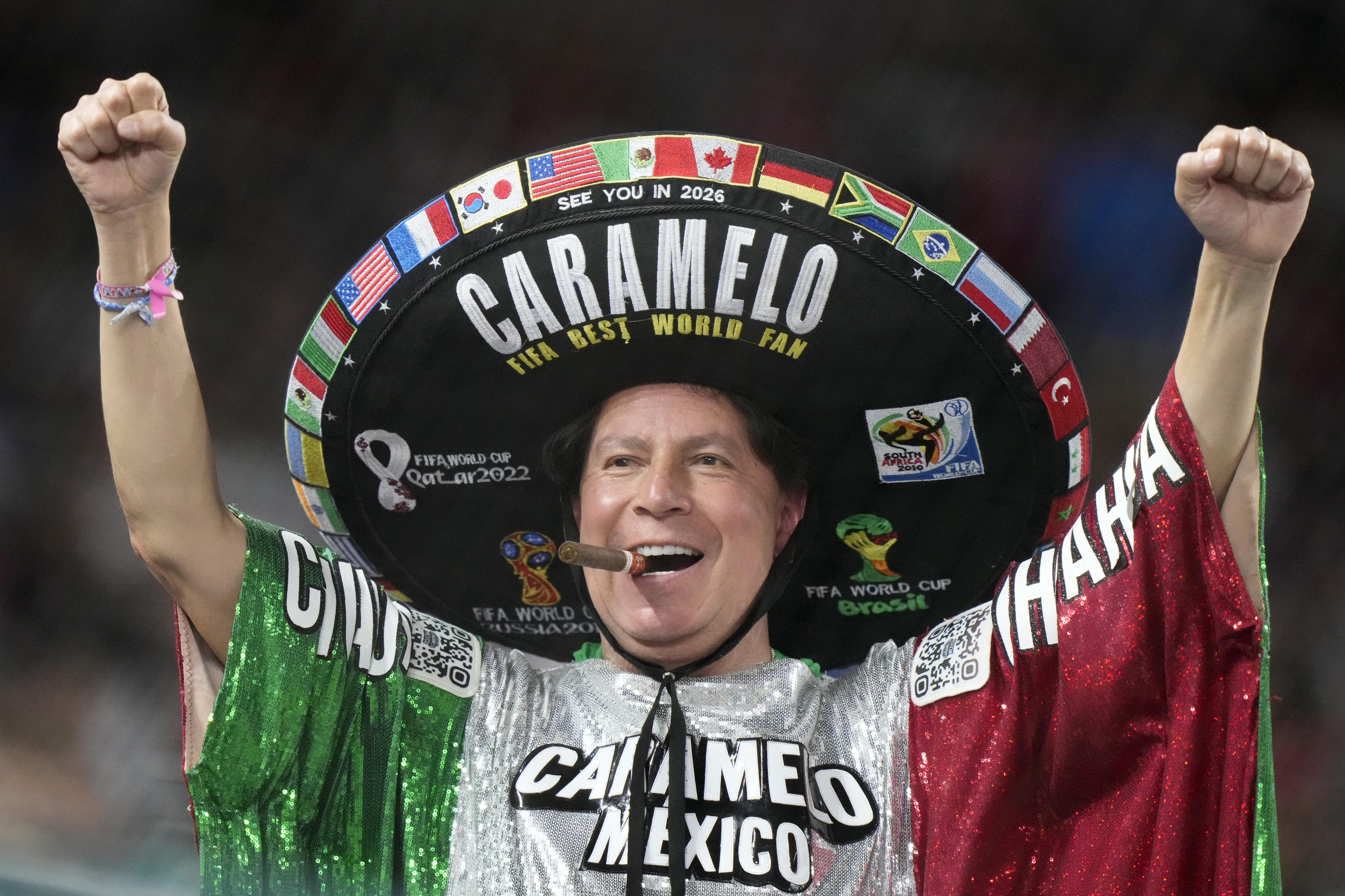 FILE -A Mexico fan cheers during the fourth inning of a World Baseball Classic game between Japan and Mexico, Monday, March 20, 2023, in Miami. Major League Baseball is heading south of the border again to play a regular season series. After previous stops in Monterrey, Mexico City will be the host this time, and the timing seems perfect.